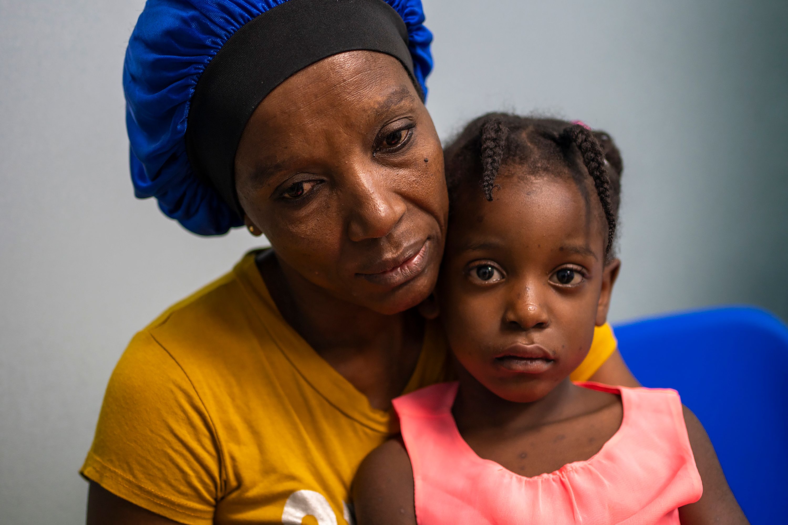 Louicamene Chery and her daughter Marie-Christine Marcelin, 4, wait at Médecins Sans Frontières emergency clinic in Port-au-Prince, Haiti, on Sunday, March 17. Since the start of the month, criminal groups have been attacking the last remnants of the Haitian state in the capital city.