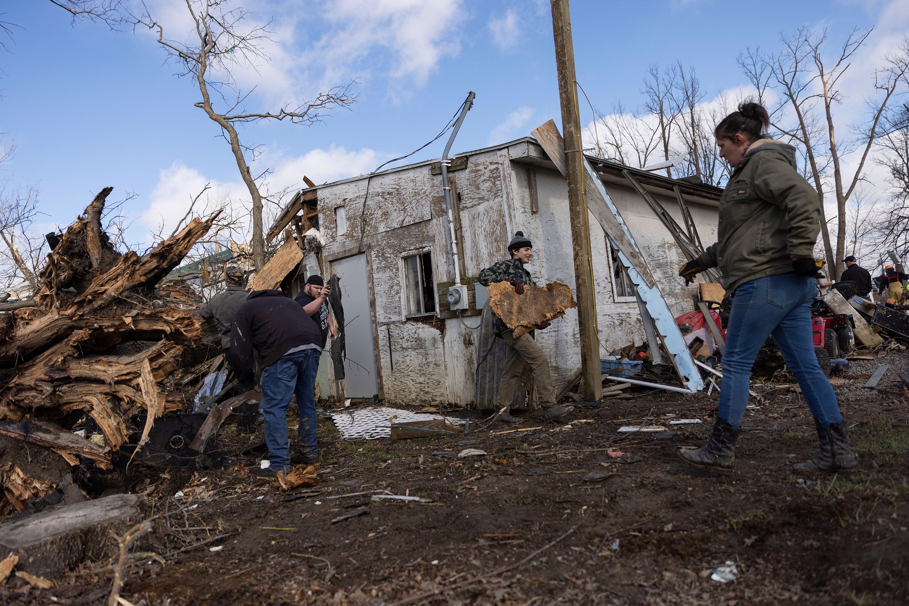 People clean up in the aftermath of a tornado in Lakeview, Ohio, on Friday, March 15.