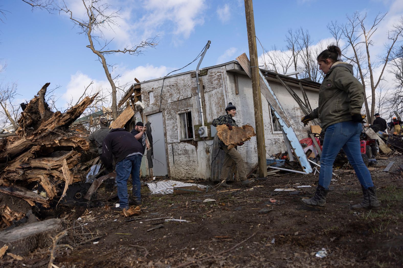 People clean up in the aftermath of a tornado in Lakeview, Ohio, on Friday, March 15. <a href="index.php?page=&url=https%3A%2F%2Fwww.cnn.com%2F2024%2F03%2F15%2Fweather%2Findiana-ohio-storm-tornado-damage-friday%2Findex.html" target="_blank">Damaging storms and tornadoes</a> swept through Indiana and Ohio, leaving at least three people dead, destroying parts of towns and prompting search and rescue efforts, officials said.