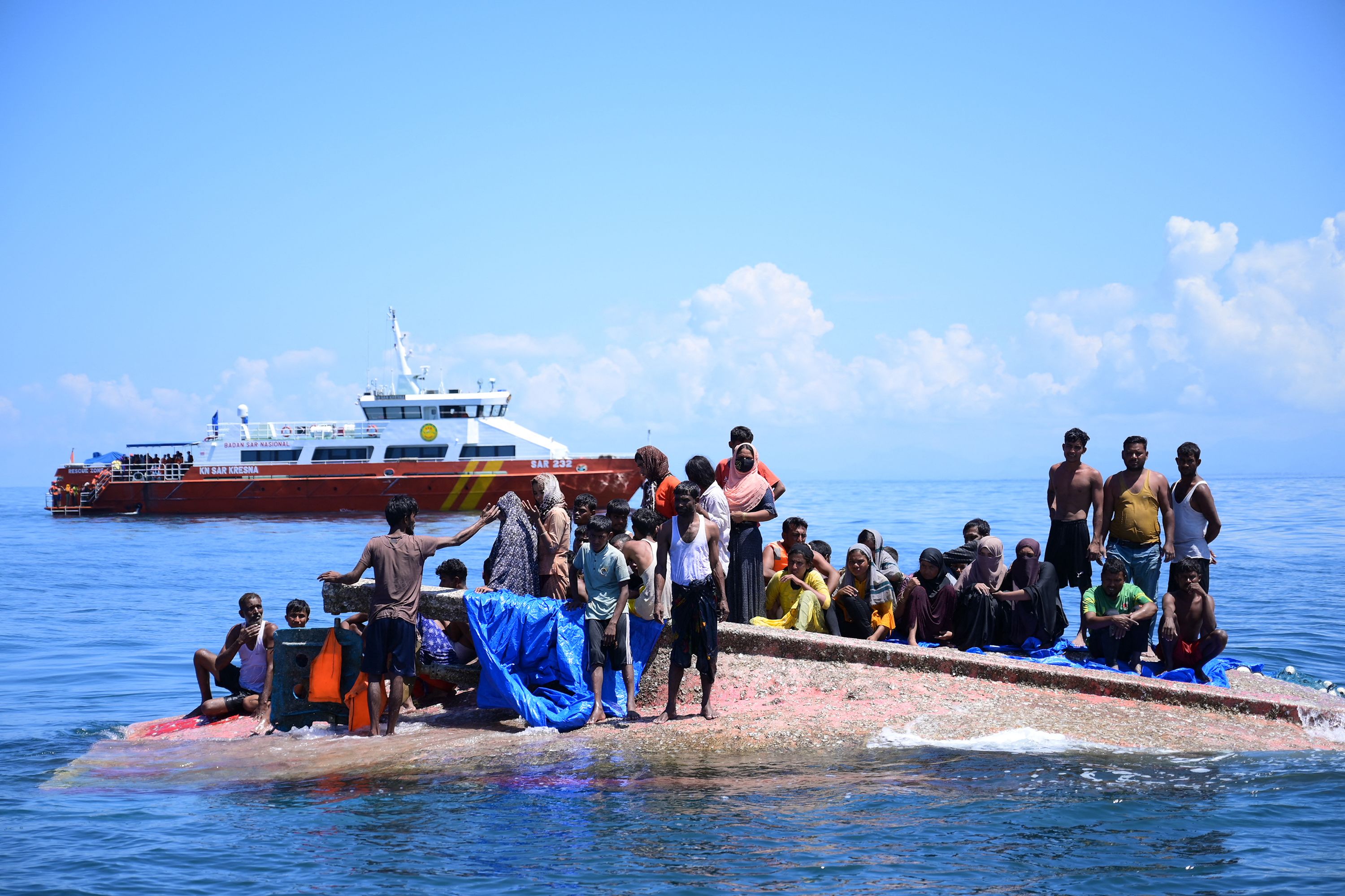 Rohingya refugees wait to be rescued from the hull of their capsized boat off West Aceh, Indonesia, on Thursday, March 21.