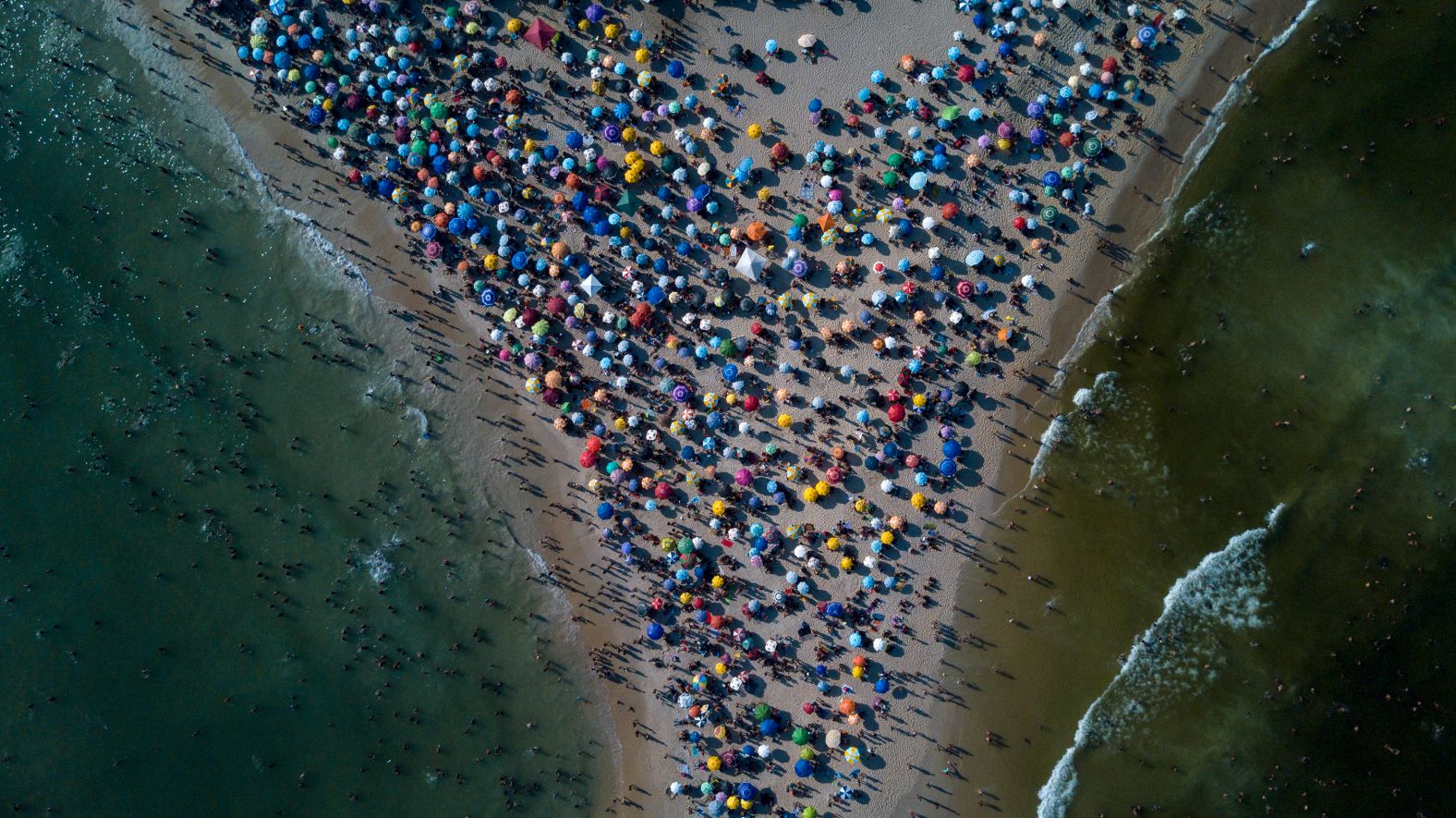 People gather at Recreio dos Bandeirantes beach amid a heat wave in Rio de Janeiro on Sunday, March 17.