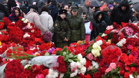 TOPSHOT - People lay flowers at a makeshift memorial in front of the Crocus City Hall in Krasnogorsk on March 24, 2024, as Russia observes a national day of mourning after a massacre that killed more than 130 people. (Photo by Olga MALTSEVA / AFP) (Photo by OLGA MALTSEVA/AFP via Getty Images)
