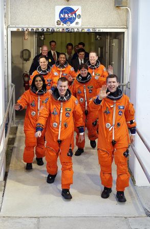 The STS-107 crew members wave to onlookers on their way to the launchpad for liftoff at the Kennedy Space Center in Florida on January 16, 2003.