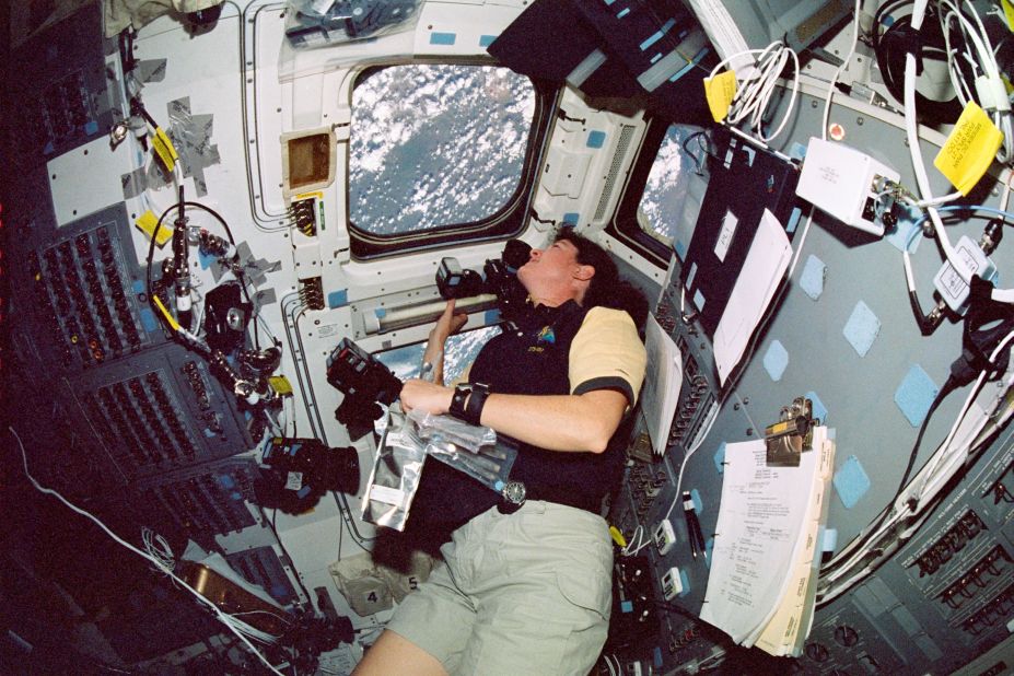 Clark looks through an overhead window on the aft flight deck of Space Shuttle Columbia. This photo was on a roll of unprocessed film that searchers later recovered from debris.