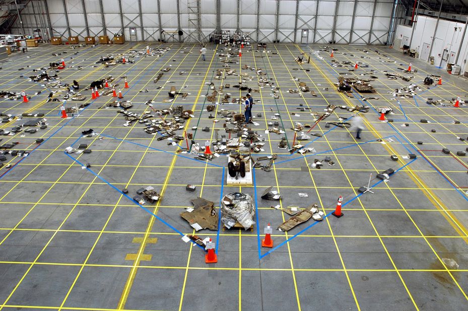 Pieces of Space Shuttle Columbia that had been identified are placed within the outline of the orbiter on the reusable launch vehicle hangar floor at the Kennedy Space Center in Florida on March 6, 2003. The Columbia Reconstruction Project Team was attempting to reconstruct the bottom of the orbiter as part of the investigation into what caused the destruction of Columbia and the loss of its crew.