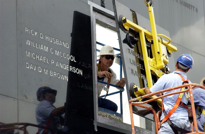 Workers add the names of the STS-107 crew to the Space Mirror Memorial on July 15, 2003. Dedicated in May 1991, the memorial <a href="index.php?page=&url=https%3A%2F%2Fwww.amfcse.org%2Fwho-we-honor" target="_blank" target="_blank">honors astronauts</a> who gave their lives for space exploration. It was created by the <a href="index.php?page=&url=https%3A%2F%2Fwww.amfcse.org%2Fspace-mirror" target="_blank" target="_blank">Astronauts Memorial Foundation</a> and is accessible through the <a href="index.php?page=&url=https%3A%2F%2Fwww.kennedyspacecenter.com%2Fexplore-attractions%2Fheroes-and-legends%2Fspace-mirror-memorial" target="_blank" target="_blank">Kennedy Space Center Visitor Complex</a> in Florida.