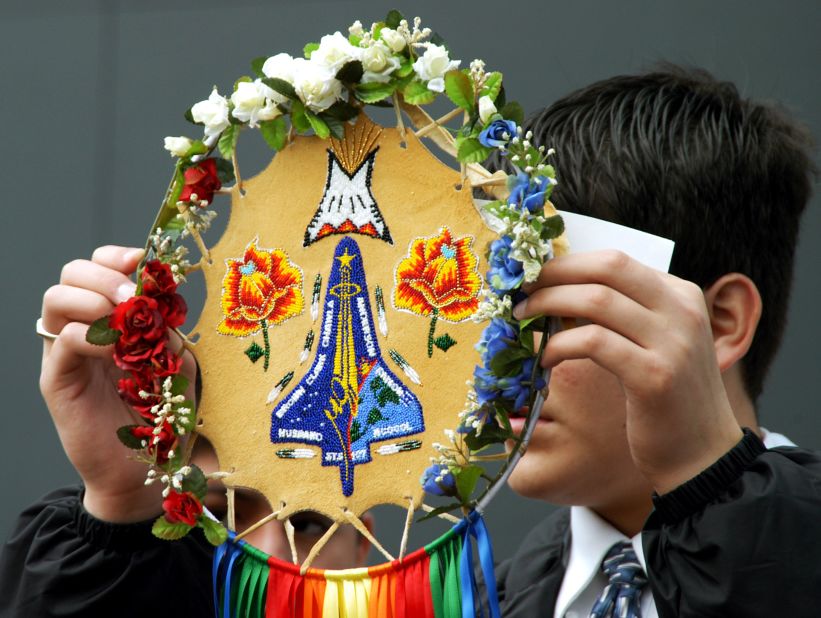 A member of the Shoshone-Bannock Native American community from Fort Hall, Idaho, displays a handmade item with the STS-107 insignia on February 1, 2004. Dancers from Shoshone-Bannock Junior/Senior High School also performed a healing ceremony during the one-year anniversary event at the Space Memorial Mirror in Florida. Students and staff of the Shoshone-Bannock High School had an experiment on board Space Shuttle Columbia.