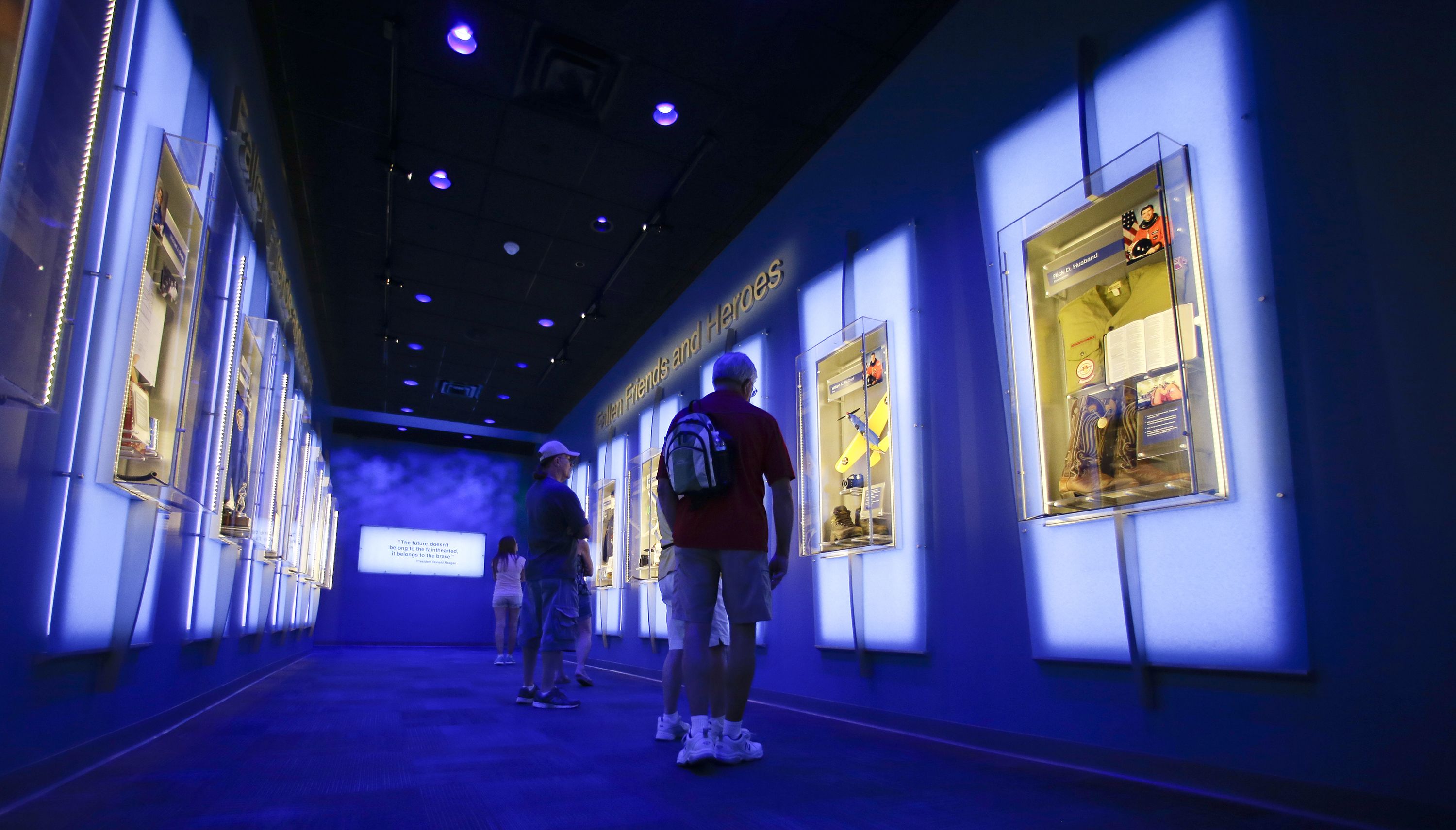 Visitors look at display cases at the 'Forever Remembered' exhibit at the Kennedy Space Center Visitor Complex in Florida, on July 21, 2015.