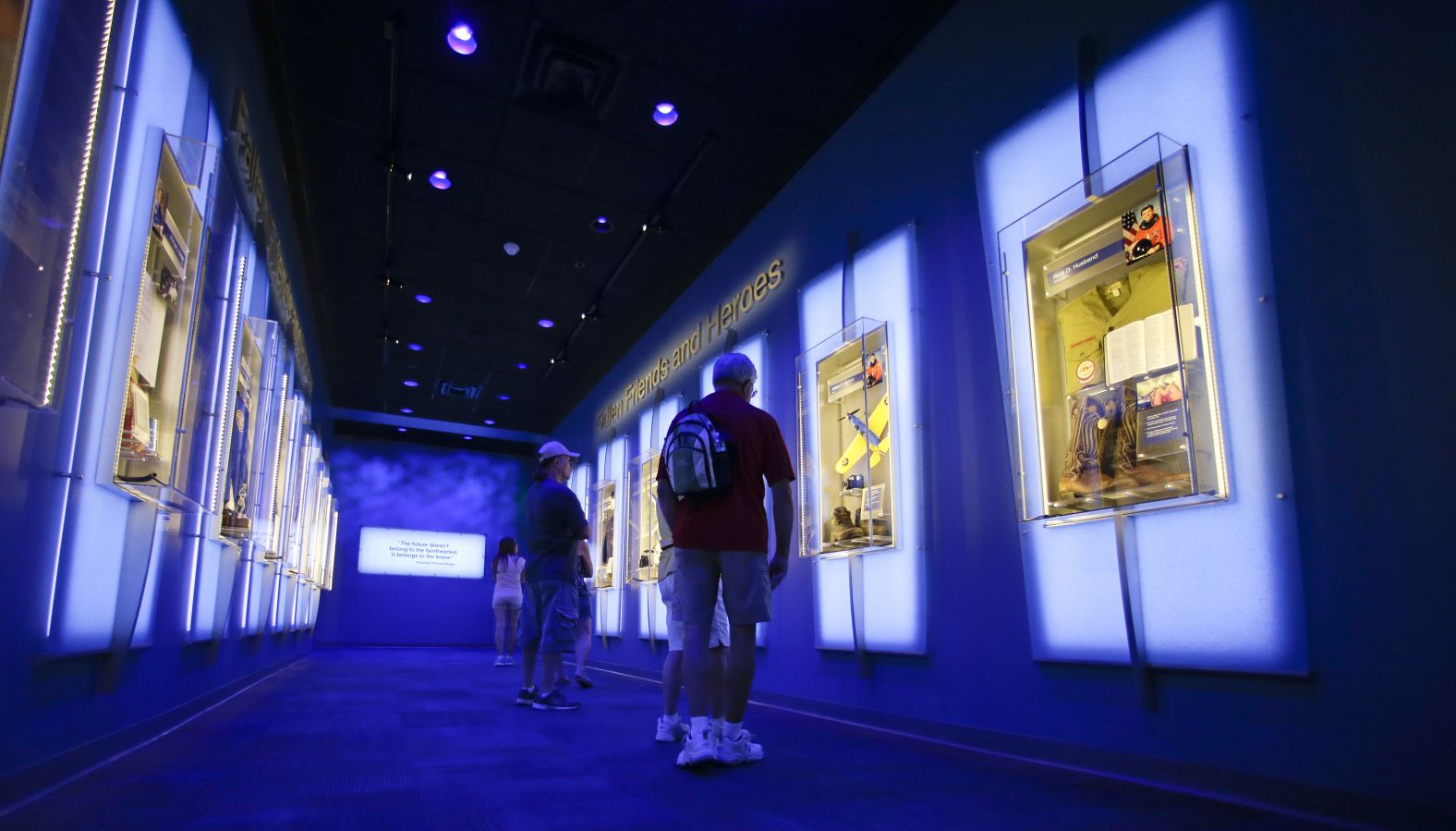Visitors look at display cases at the "Forever Remembered" exhibit for the astronauts who died on the Columbia and Challenger space shuttles, at the Kennedy Space Center Visitor Complex in Florida, on July 21, 2015. <a href="index.php?page=&url=https%3A%2F%2Fwww.kennedyspacecenter.com%2Fexplore-attractions%2Fshuttle-a-ship-like-no-other%2Fforever-remembered" target="_blank" target="_blank">The exhibit</a> is permanent and "displays personal items from each astronaut and recovered hardware from both orbiters, including a section of Challenger's left fuselage with American flag and the framework of Columbia's cockpit windows," according to the Kennedy Space Center website.