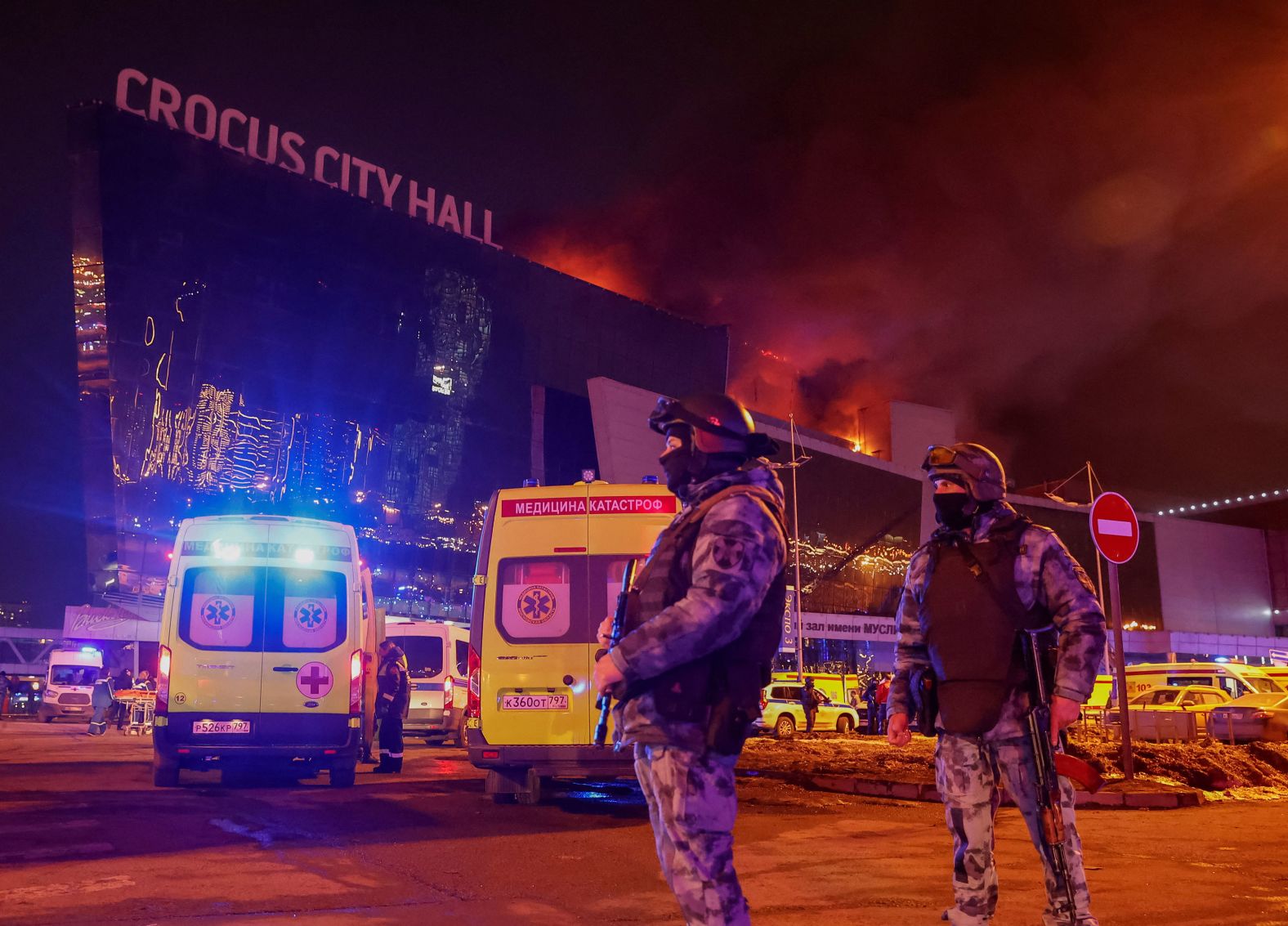 Law enforcement officers stand guard near the burning Crocus City Hall concert venue after a <a href="index.php?page=&url=https%3A%2F%2Fwww.cnn.com%2F2024%2F03%2F25%2Feurope%2Frussia-moscow-concert-attack-suspects-court-intl%2Findex.html" target="_blank">terrorist attack in Moscow</a> on Friday, March 22. ISIS has claimed responsibility for the massacre, which saw armed assailants storm the complex, killing at least 139 people. Nearly a dozen people have been detained in connection with the attack, according to authorities.
