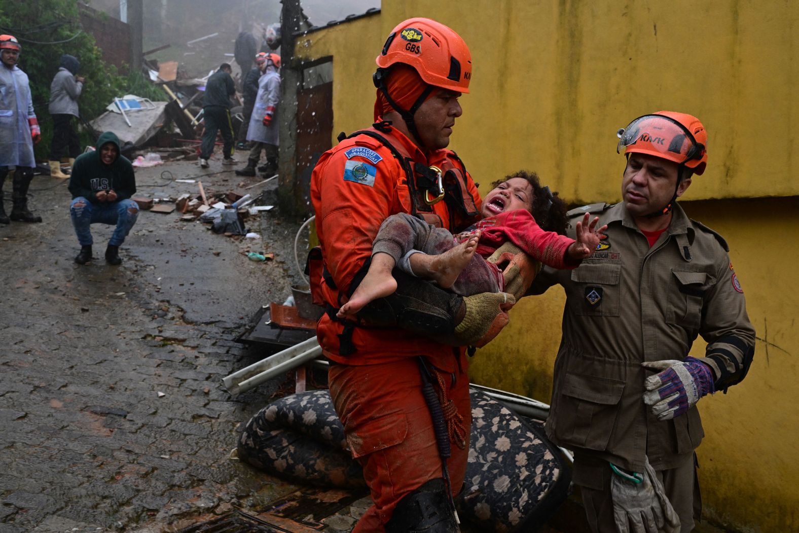 A Civil Defense worker carries a girl who was rescued from the rubble of her house, which was destroyed by <a href="index.php?page=&url=https%3A%2F%2Fwww.cnn.com%2F2024%2F03%2F25%2Fclimate%2Fbrazil-flooding-landslide-climate-intl%2Findex.html" target="_blank">heavy rains</a> in Petrópolis, Brazil, on Saturday, March 23.
