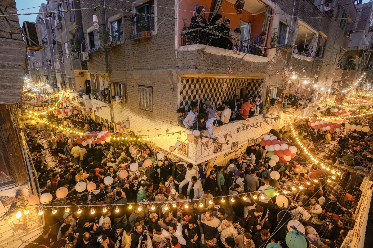People in Cairo's El Matareya break their Ramadan fast together on Monday, March 25.