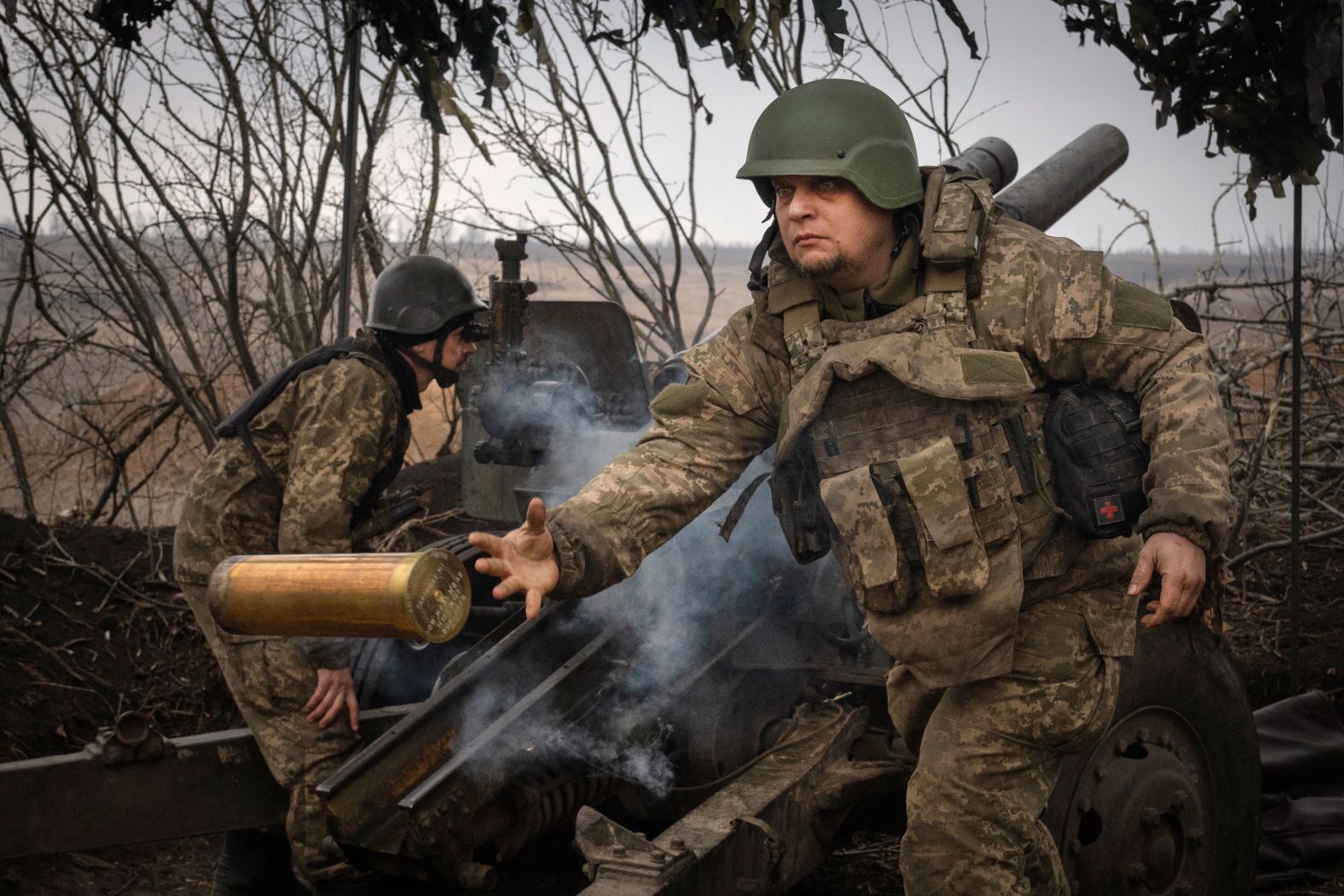 Ukrainian soldiers fire a howitzer toward Russian positions near Avdiivka, Ukraine, on Friday, March 22.