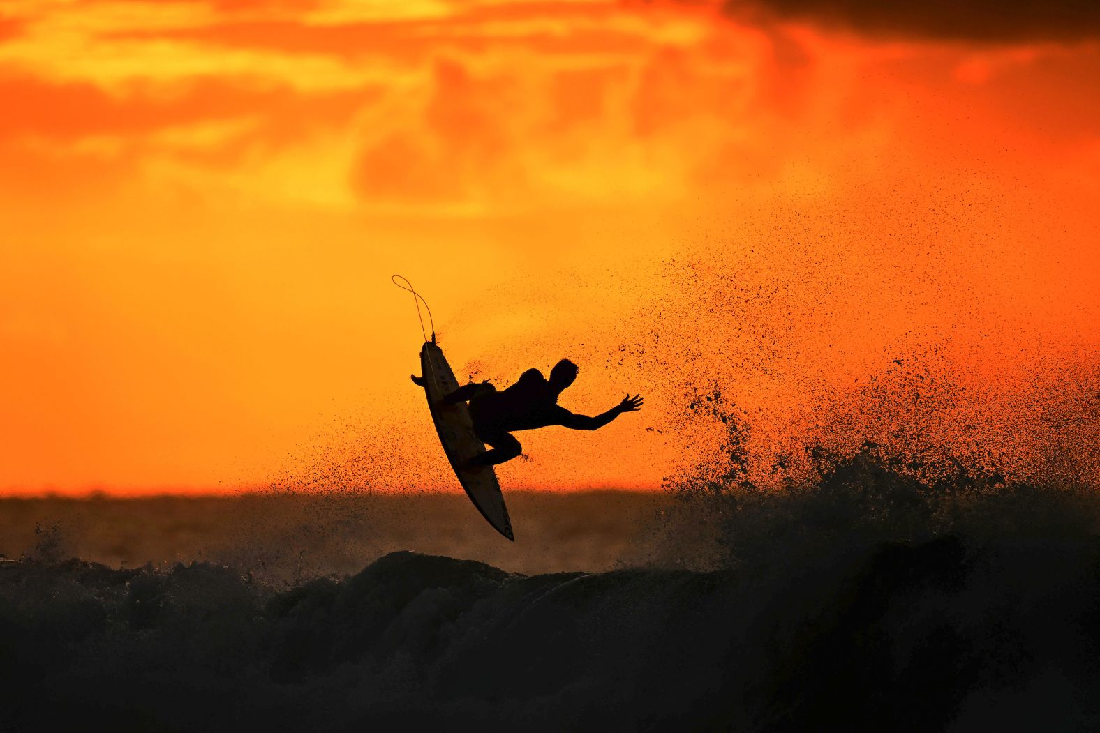A surfer warms up at sunrise before a professional event in Bells Beach, Australia, on Wednesday, March 27.