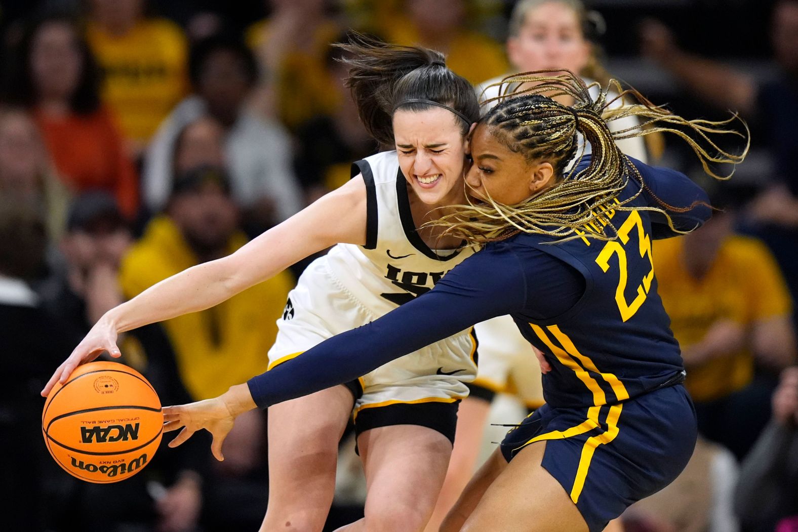 West Virginia guard Lauren Fields tries to steal the ball from Iowa guard Caitlin Clark during an NCAA Tournament game on Monday, March 25. <a href="index.php?page=&url=https%3A%2F%2Fwww.cnn.com%2F2024%2F03%2F25%2Fsport%2Fiowa-womens-basketball-ncaa-tournament-spt%2Findex.html" target="_blank">Iowa advanced to the Sweet Sixteen with a 64-54 victory</a>, and Clark's 32 points gave her the NCAA Division I women's record for most points scored in a single season (1,113).