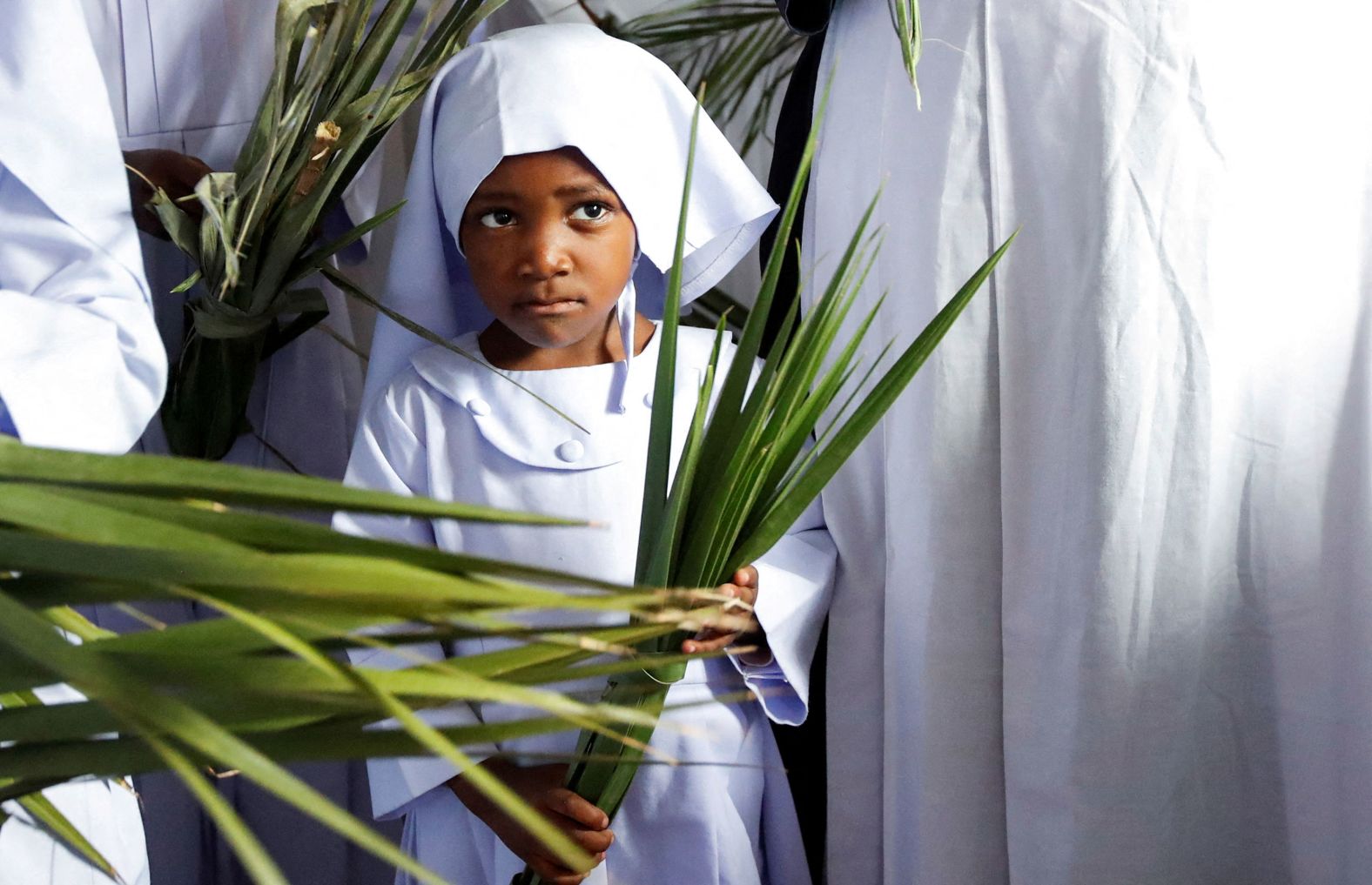 A child holds palm leaves as she attends a Palm Sunday Mass in Nairobi, Kenya, on March 24.
