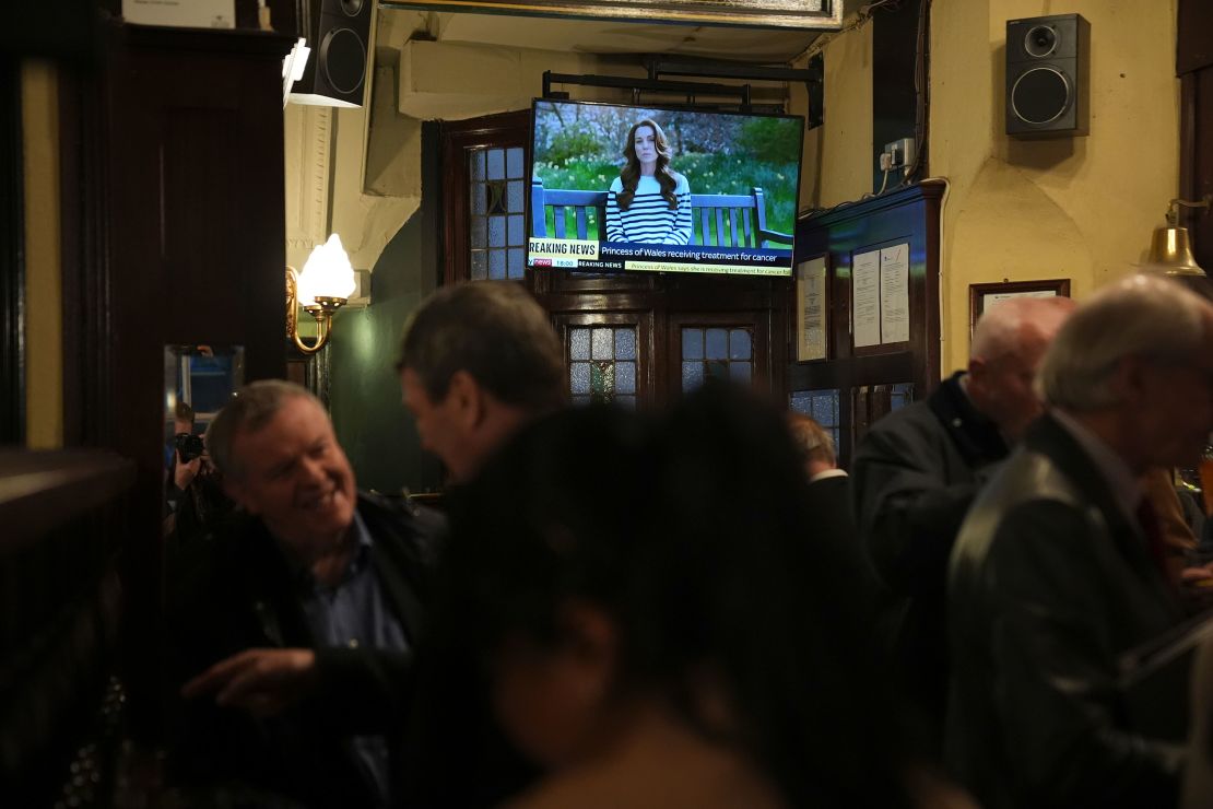 People watch a broadcast of an announcement by the Princess of Wales, in the Westminster Arms public house in Westminster. The Princess of Wales has revealed she is undergoing chemotherapy treatment for cancer. She announced the news in a pre-recorded message that was broadcast on Friday evening. Issue date: Friday March 22, 2024. 75689865 (Press Association via AP Images)