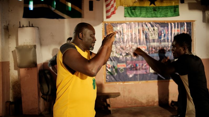 Charles Quartey, left, is a former amateur fighter who now runs a prominent gym, which helps gets children off the streets. "We take care of them," he says. "We clothe them, we feed them, we send them to school. We're trying to do our best so that these boys will not grow up wasted in the community."