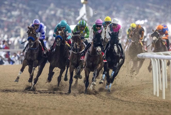 The Dubai World Cup is among the world's biggest horse racing events, with a total of more than $30 million in prize money. Pictured, 2024 winner Laurel River, with jockey Tadhg O'Shea, leads horses into the first turn at the main race.