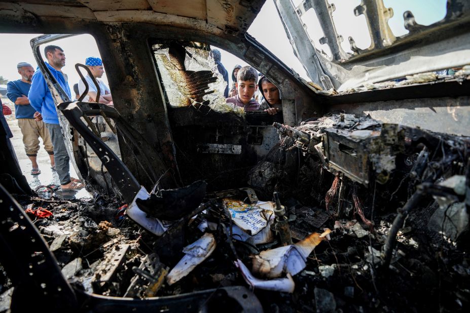 People inspect the site where World Central Kitchen workers were killed by an Israeli airstrike in Deir al-Balah, Gaza. The photo was taken on Tuesday, April 2, a day after the strike.