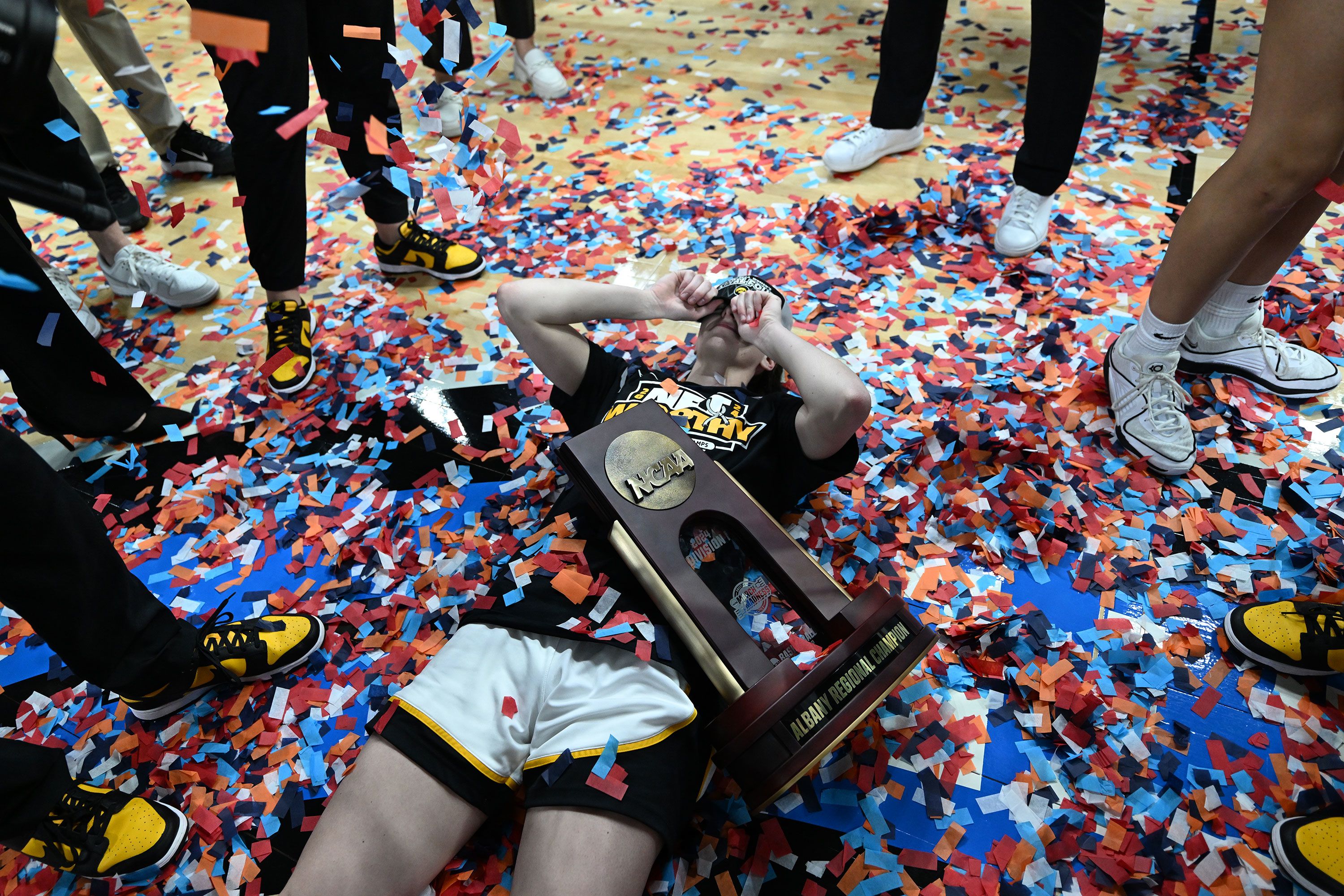 Confetti falls around Iowa superstar Caitlin Clark after the Hawkeyes defeated LSU.