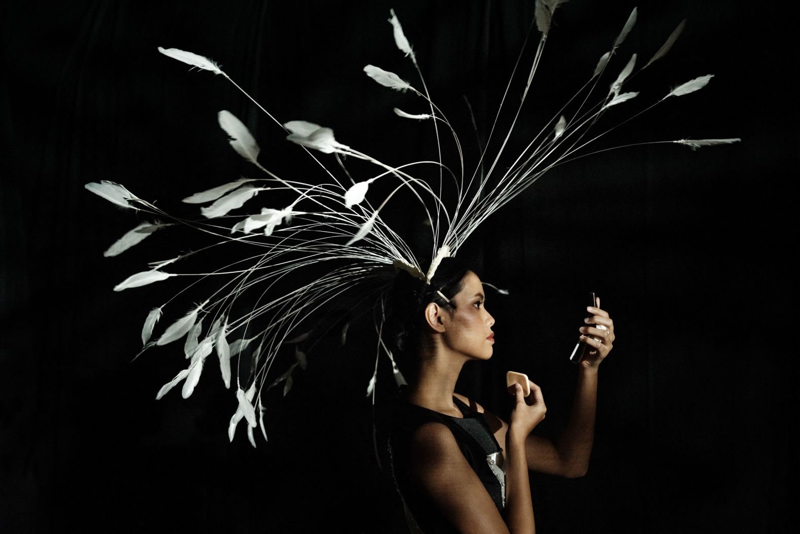 A model wearing a creation by Arjun Putra checks her makeup backstage during a fashion show in Jakarta, Indonesia, on Sunday, March 31.