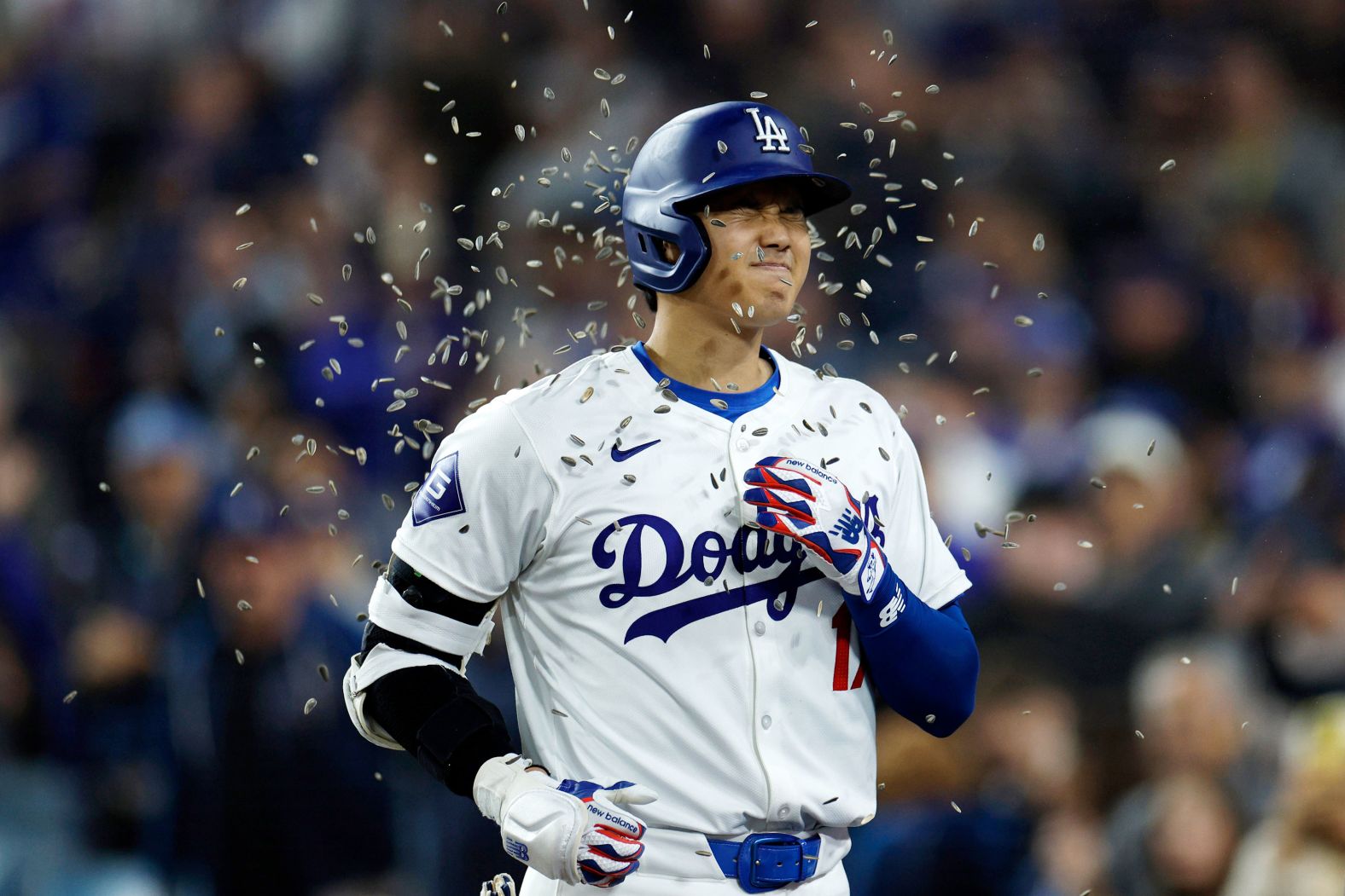 Los Angeles Dodgers star Shohei Ohtani is showered with sunflower seeds by teammate Teoscar Hernandez, not pictured, after hitting his first home run as a Dodger on Wednesday, April 3. Ohtani signed an unparalleled 10-year, $700 million deal with the Dodgers this offseason.
