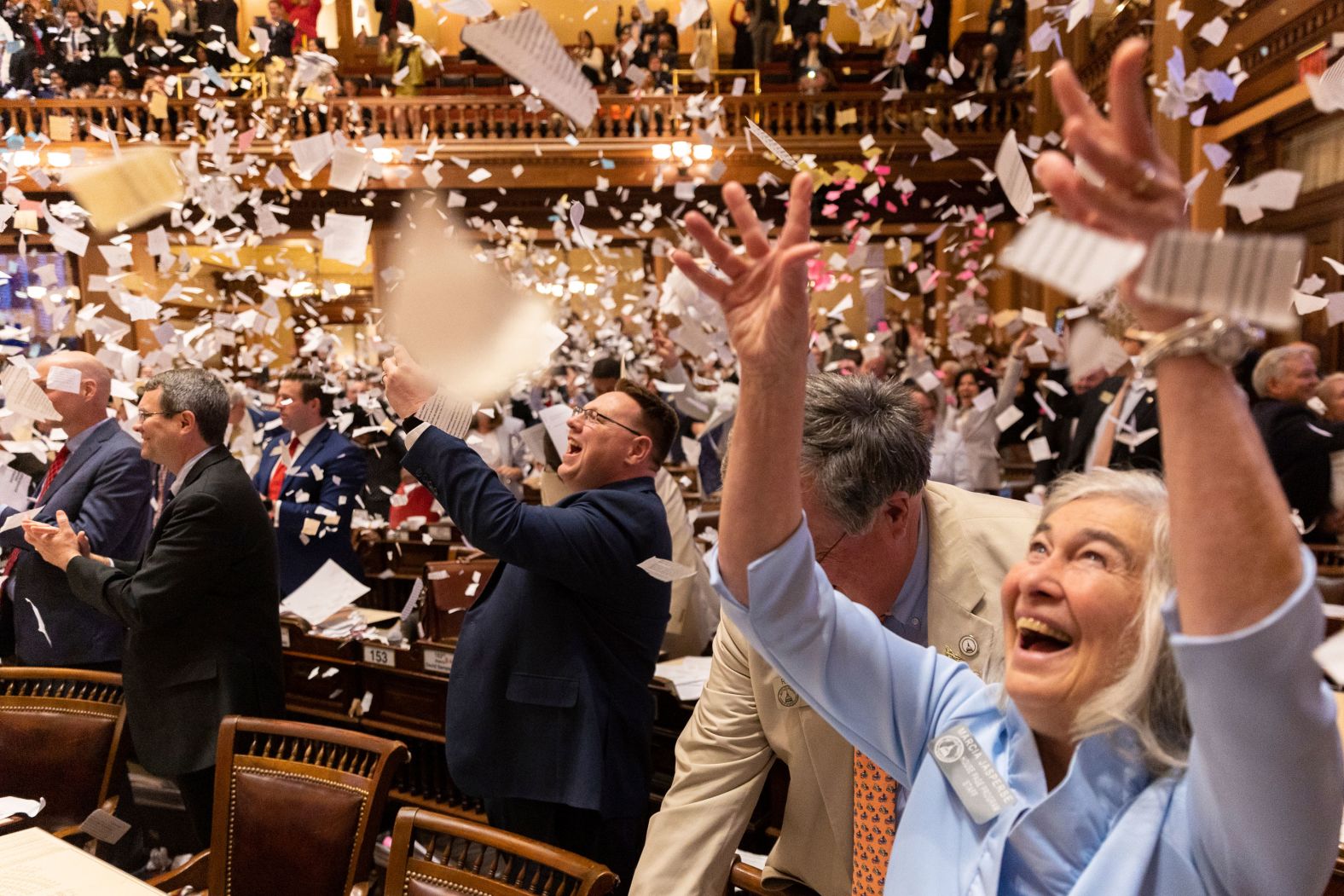 Georgia state representatives throw paper in the air to celebrate the end of the legislative session in Atlanta on Thursday, March 28.