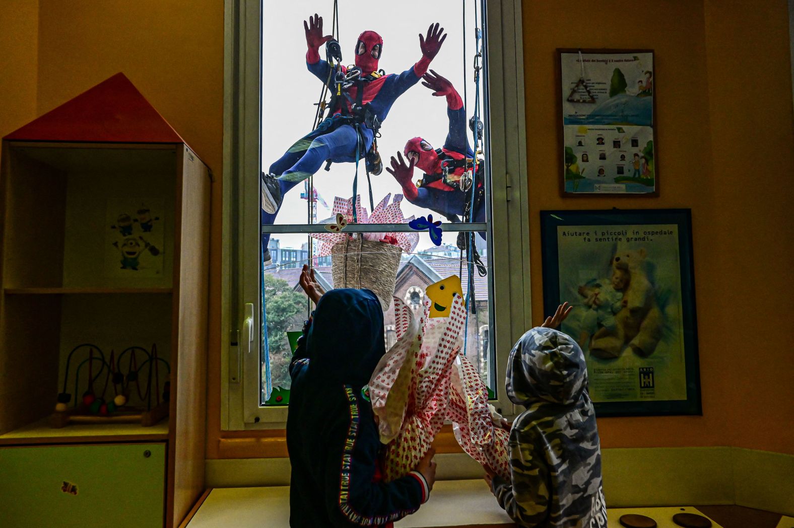 People dressed as Spider-Man deliver Easter eggs to children in the pediatric ward of the De Marchi clinic in Milan, Italy, on Thursday, March 28.