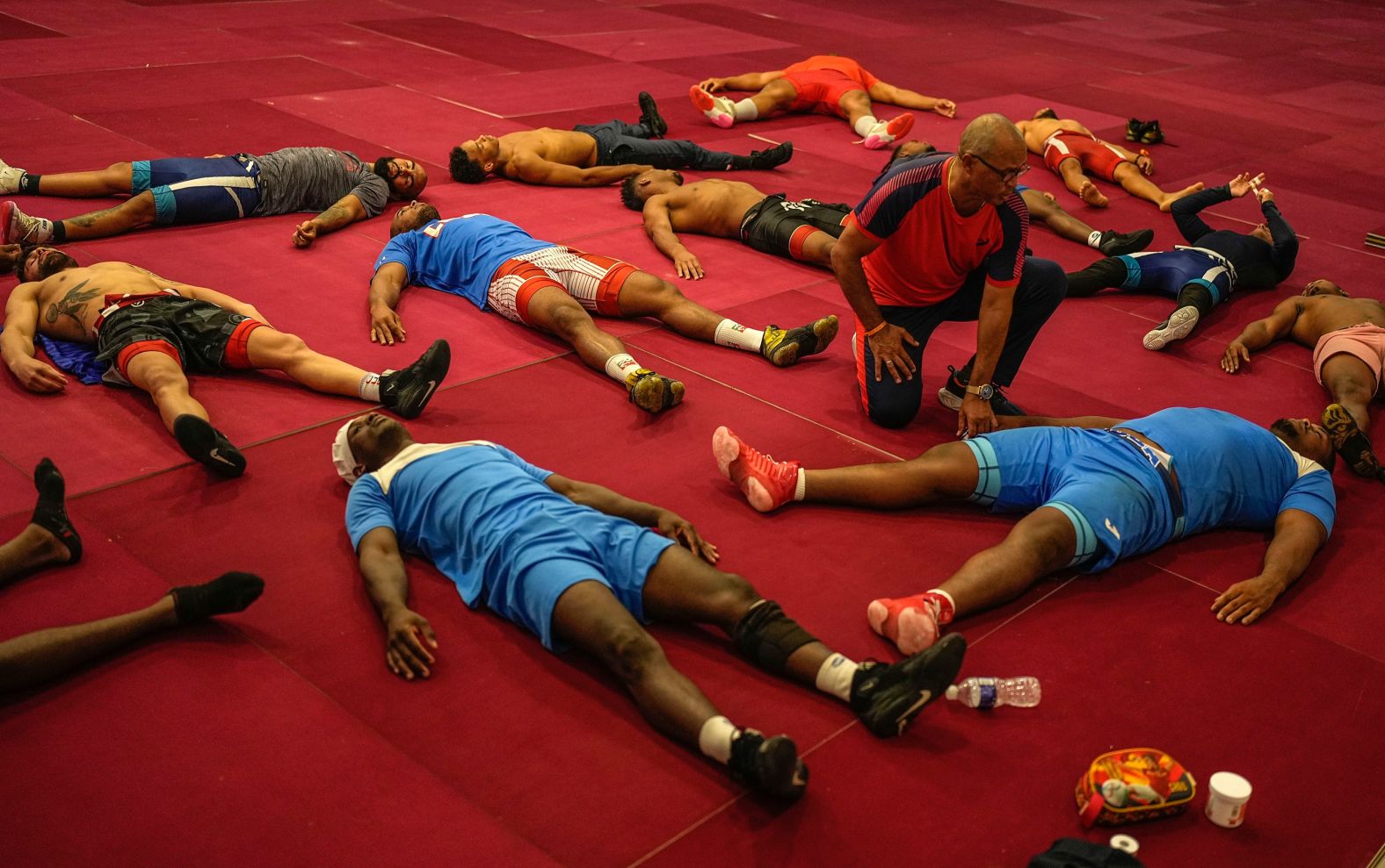 Members of Cuba's Greco-Roman wrestling team stretch out on the mat during a training session in Varadero, Cuba, on Wednesday, April 3.