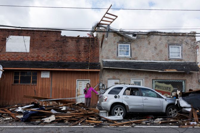 A woman exits a tornado-damaged building in Sunbright, Tennessee, on Wednesday, April 3. <a href="https://www.cnn.com/2024/04/03/us/power-outages-ohio-valley-storms-tornadoes/index.html" target="_blank">Sixteen tornadoes were reported Tuesday and Wednesday morning</a> across Illinois, Kentucky, Ohio, Alabama, Tennessee and Georgia.