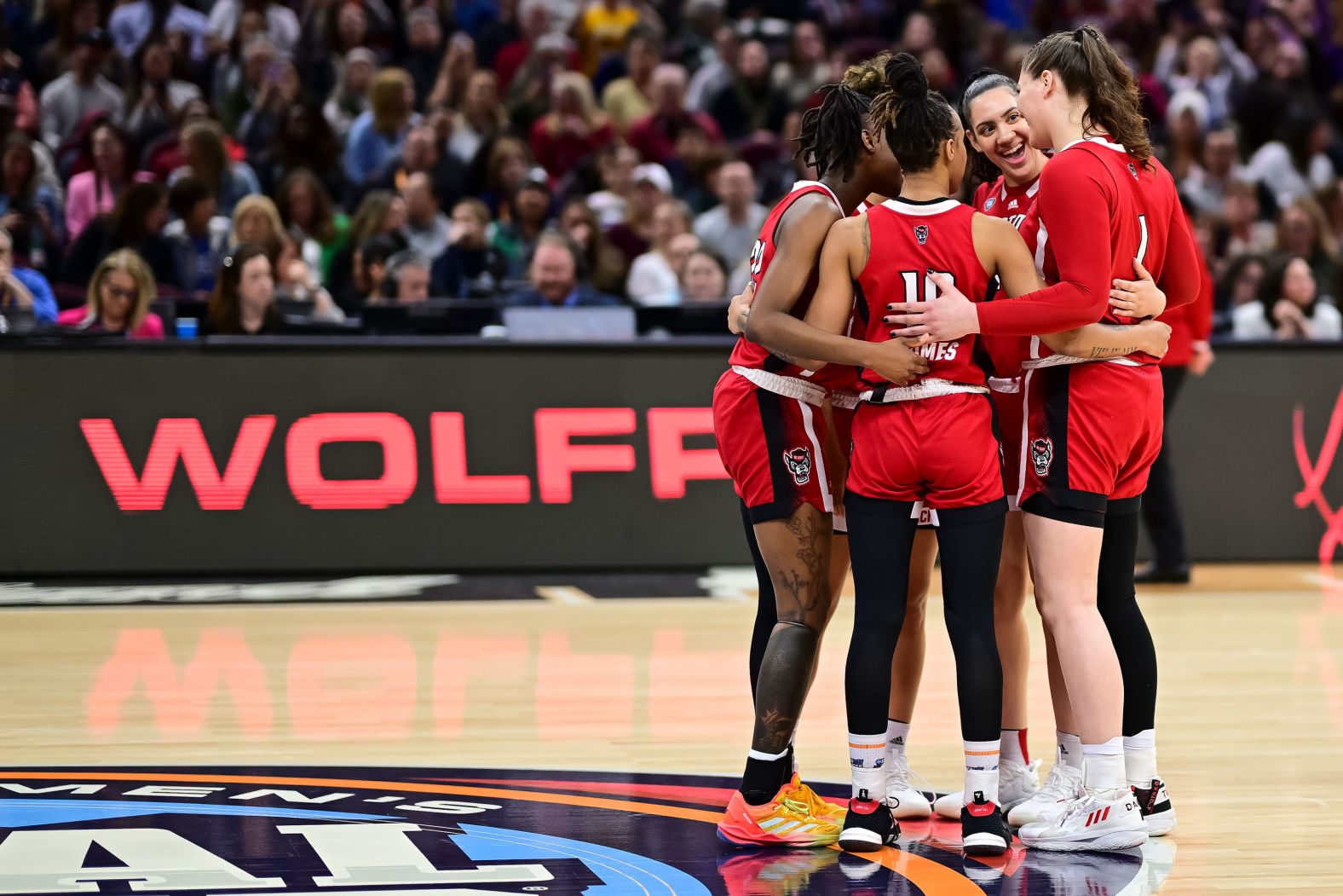 NC State Wolfpack players huddle together before tipoff.