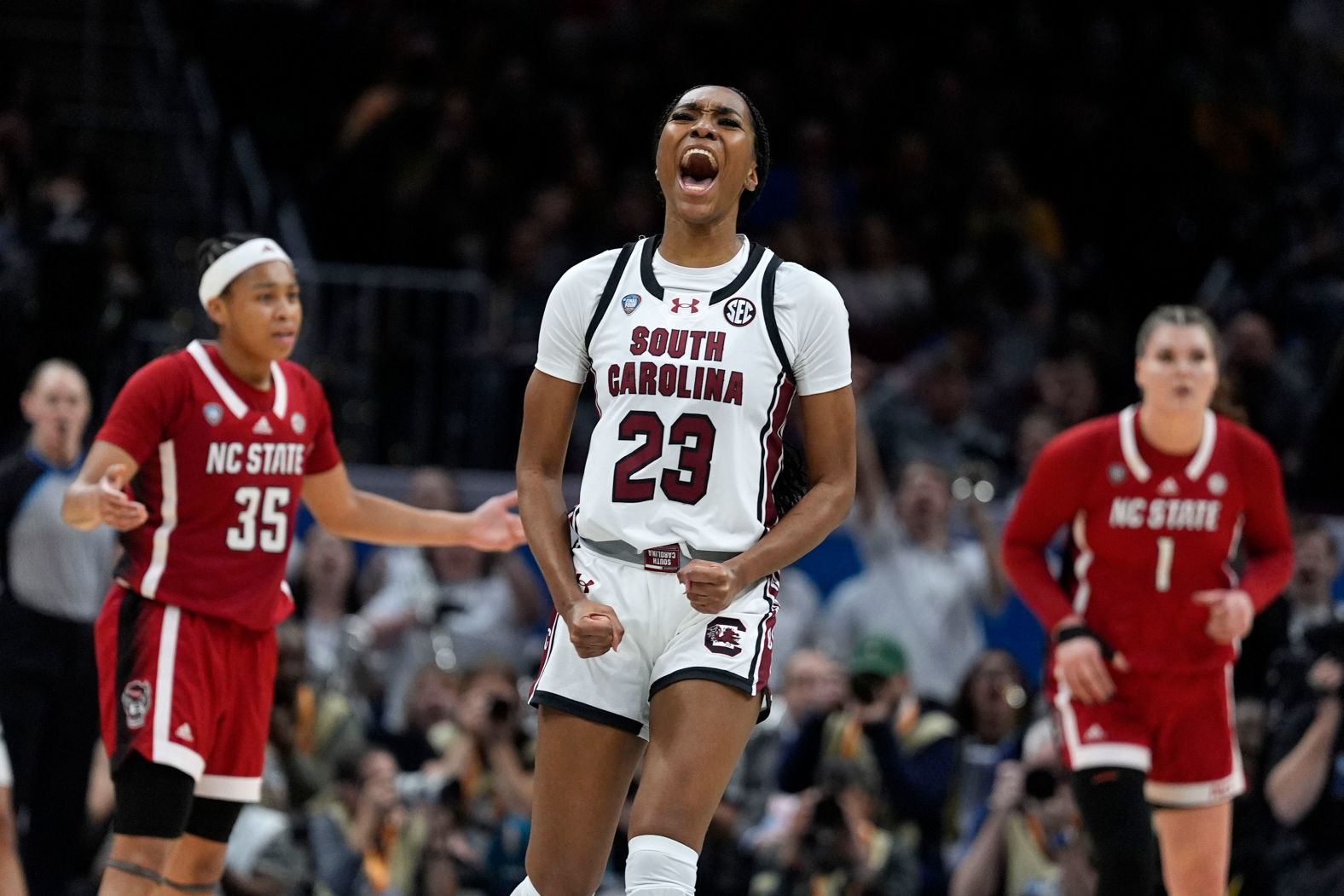 Hall celebrates after making a three-point basket during the second half.