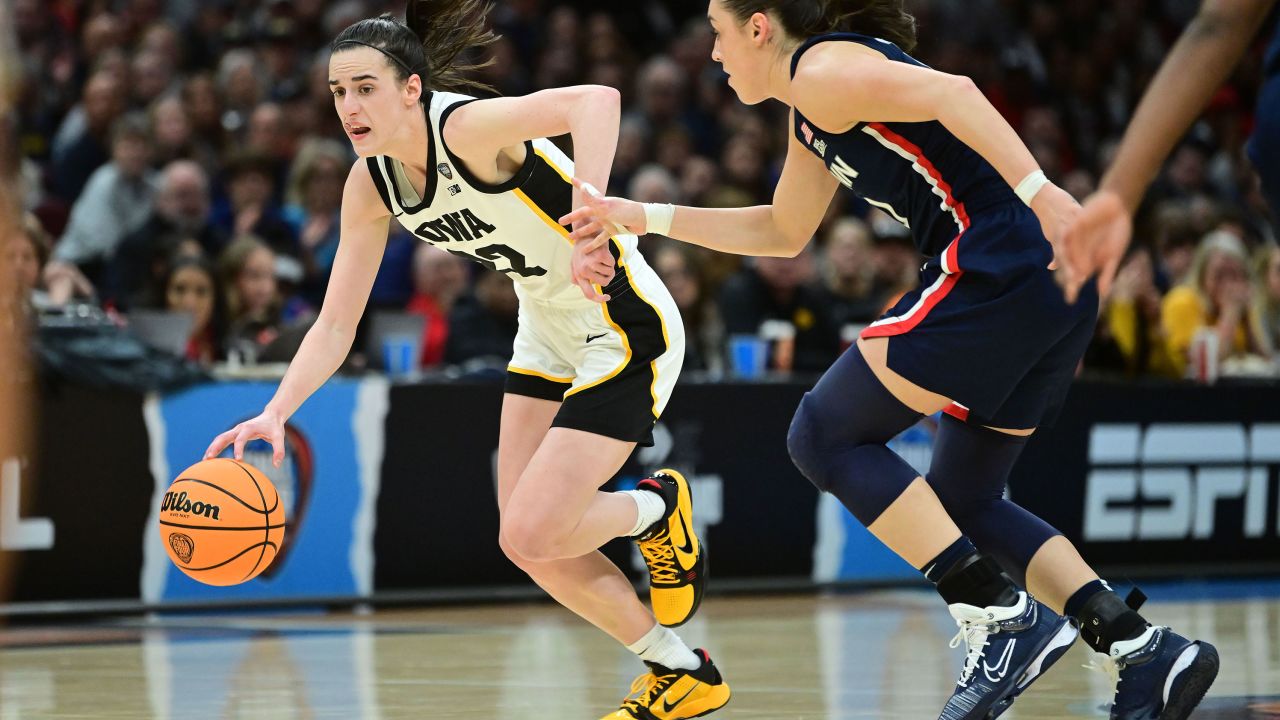 Apr 5, 2024; Cleveland, OH, USA; Iowa Hawkeyes guard Caitlin Clark (22) dribbles the ball past Connecticut Huskies guard Nika Muhl (10) in the semifinals of the Final Four of the womens 2024 NCAA Tournament at Rocket Mortgage FieldHouse. Mandatory Credit: Ken Blaze-USA TODAY Sports