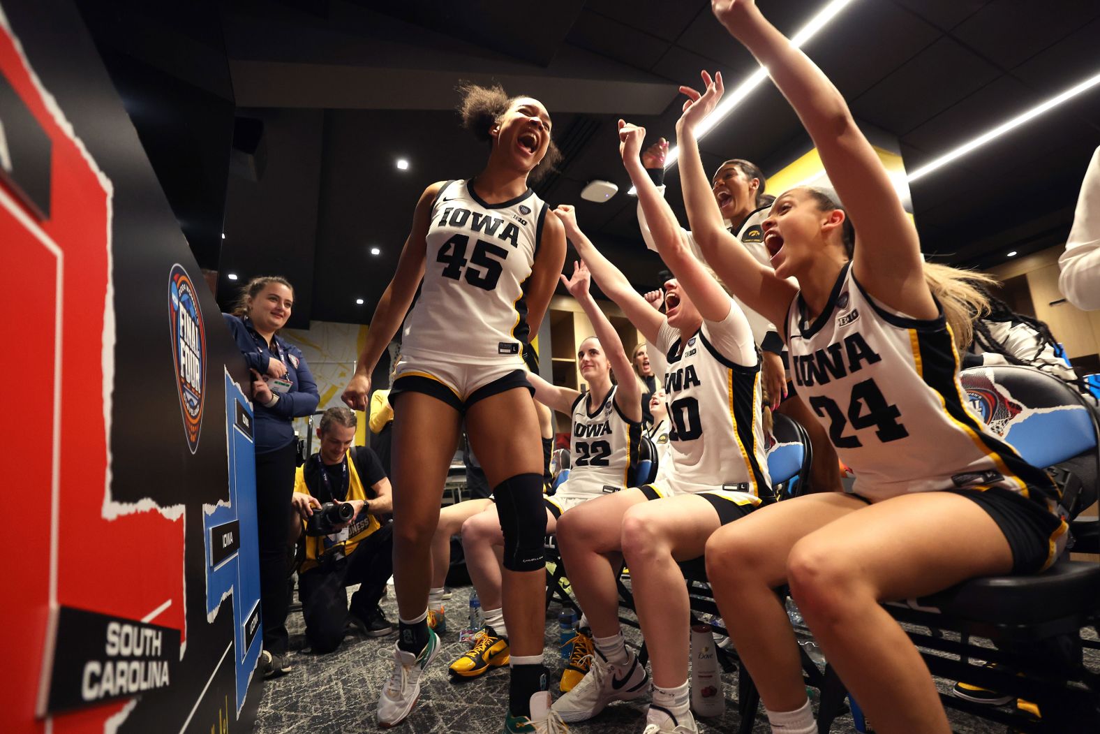 The Iowa Hawkeyes celebrate after beating the UConn Huskies 71-69 in a Final Four semifinal game at Rocket Mortgage Fieldhouse on Friday, April 5, in Cleveland. 