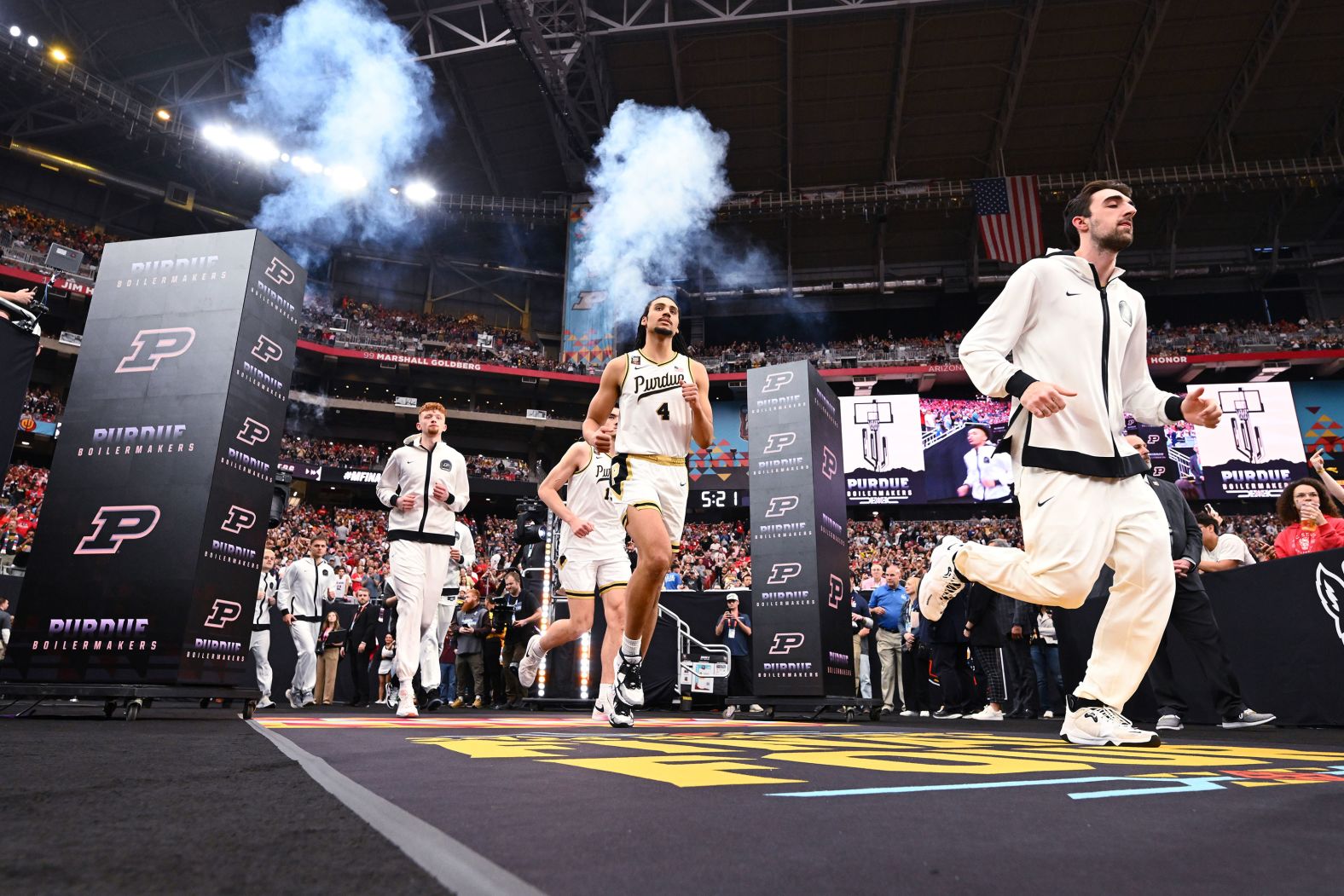 The Boilermakers run out into the stadium ahead of the game.