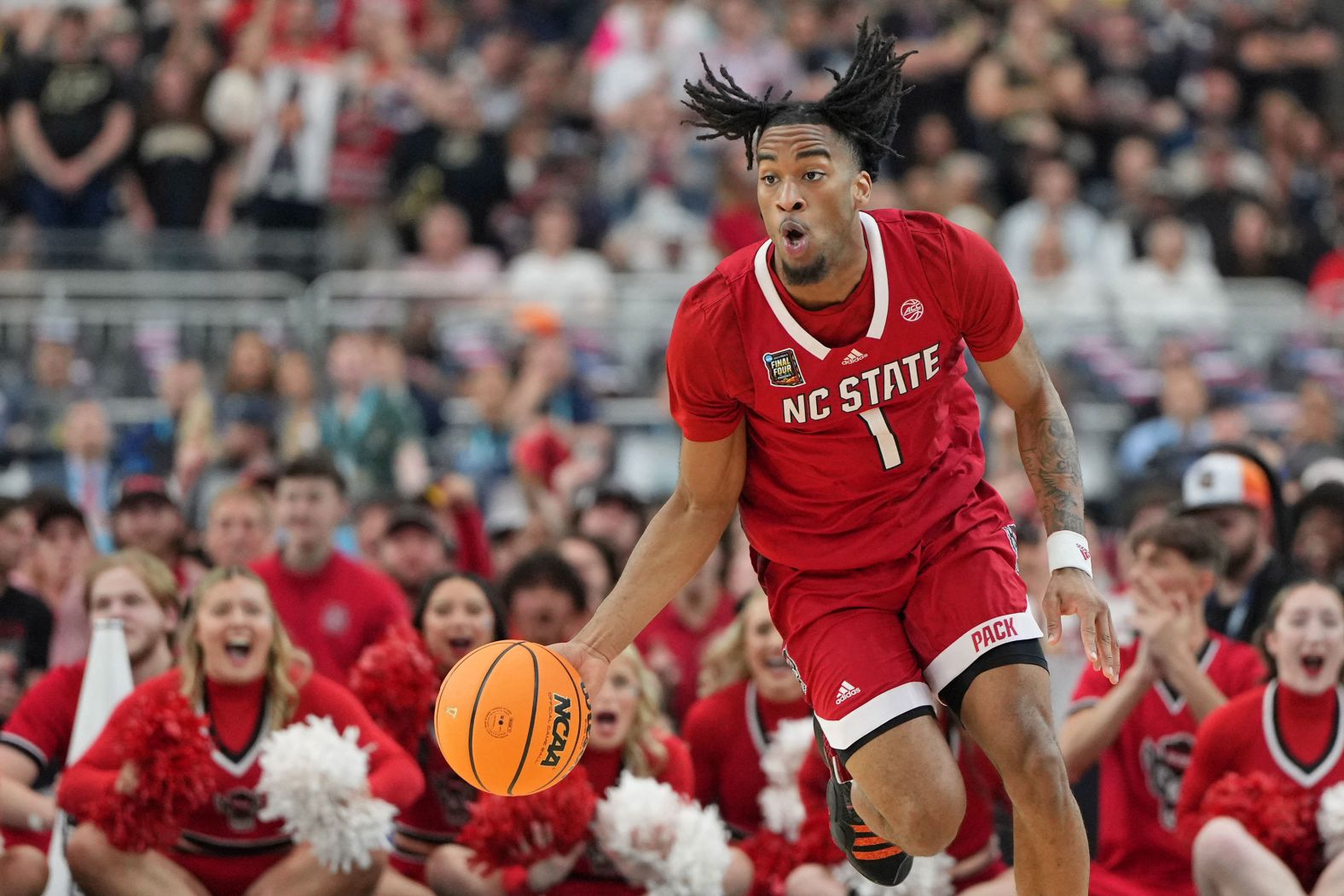 Wolfpack guard Jayden Taylor dibbles the ball. 