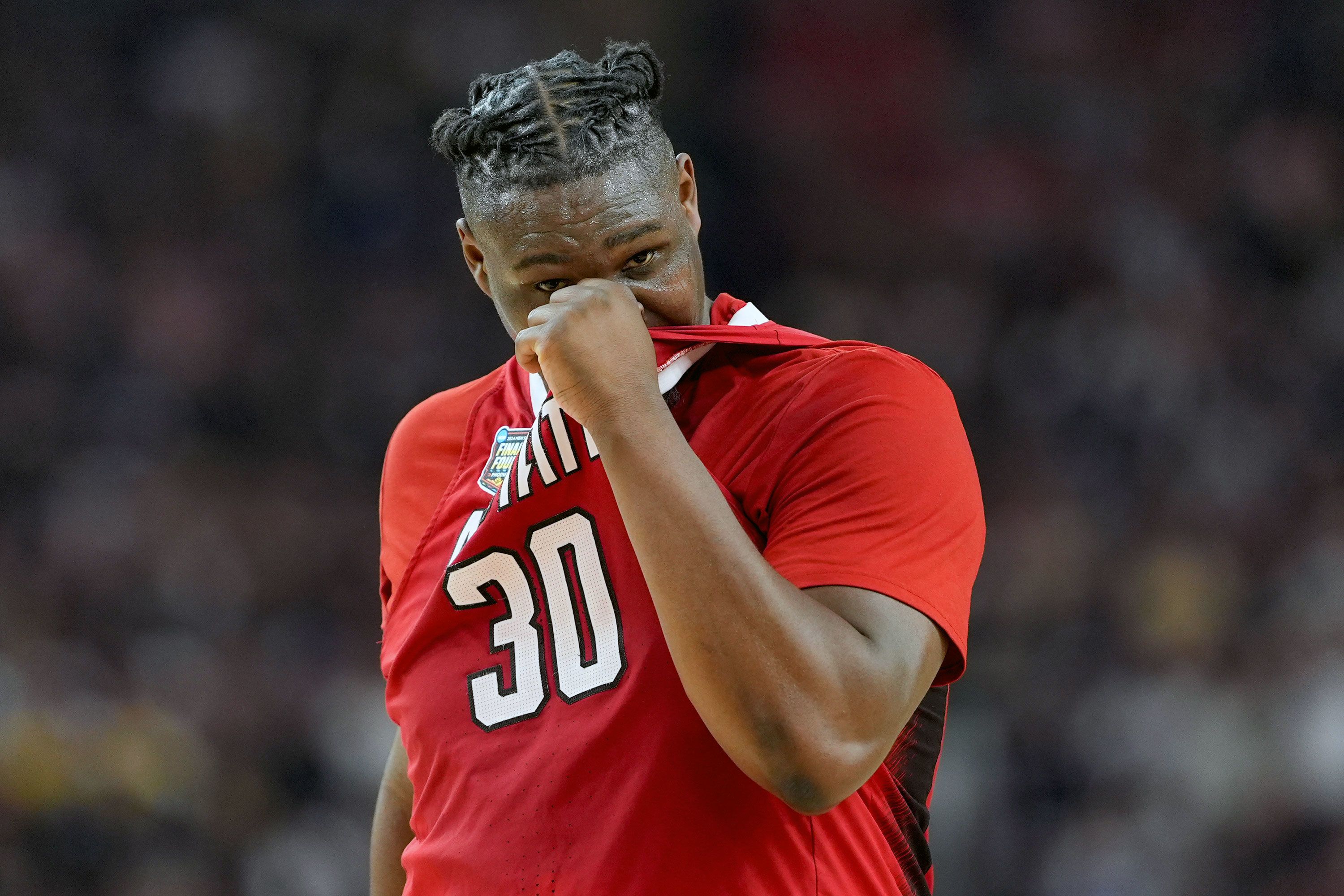 NC State forward DJ Burns Jr. walks off the court after losing to Purdue.