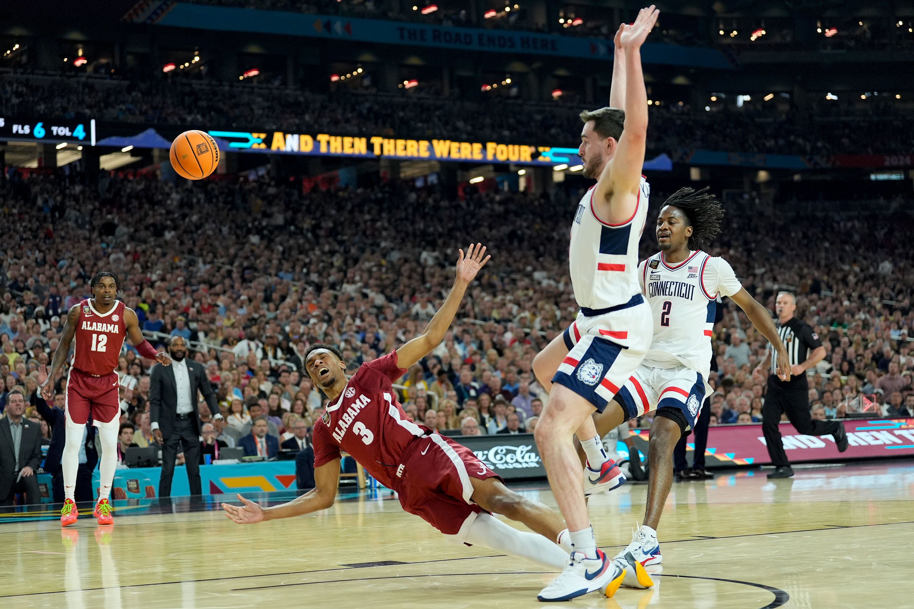 UConn forward Alex Karaban fouls Alabama guard Rylan Griffen in the first half.