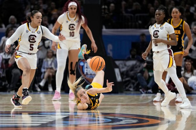 Iowa guard Kylie Feuerbach, center, fights for a loose ball with South Carolina guards Tessa Johnson, left, and Fulwiley, right.