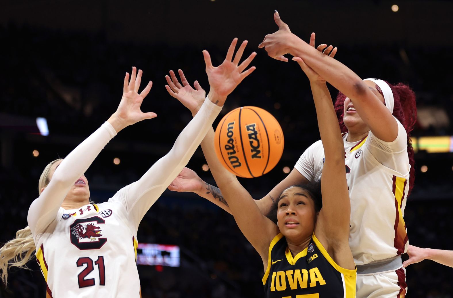 Stuelke and South Carolina's Chloe Kitts, left, and Cardoso eye a loose ball.