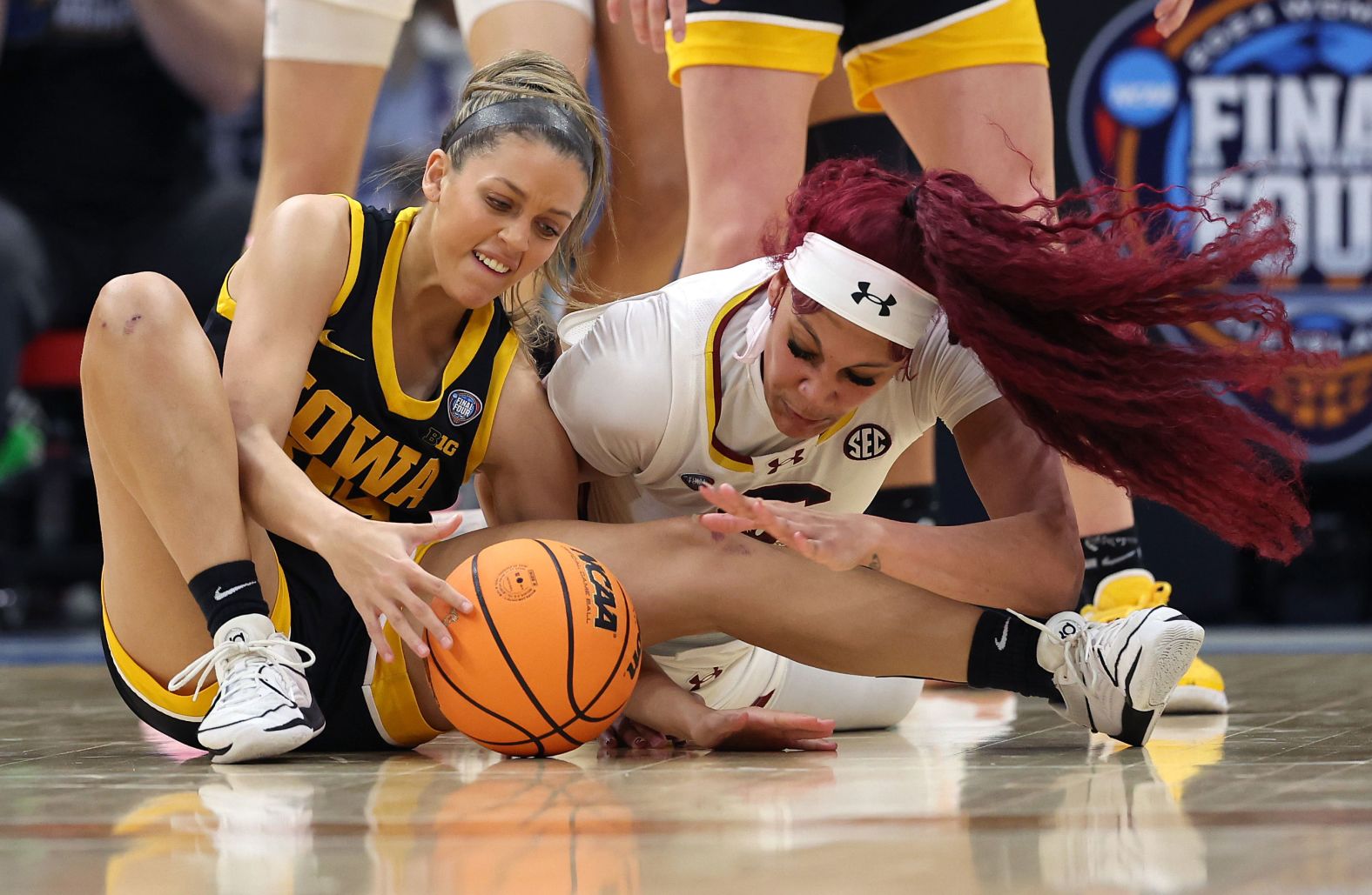 Iowa's Gabbie Marshall and Cardoso of South Carolina fight for the ball.