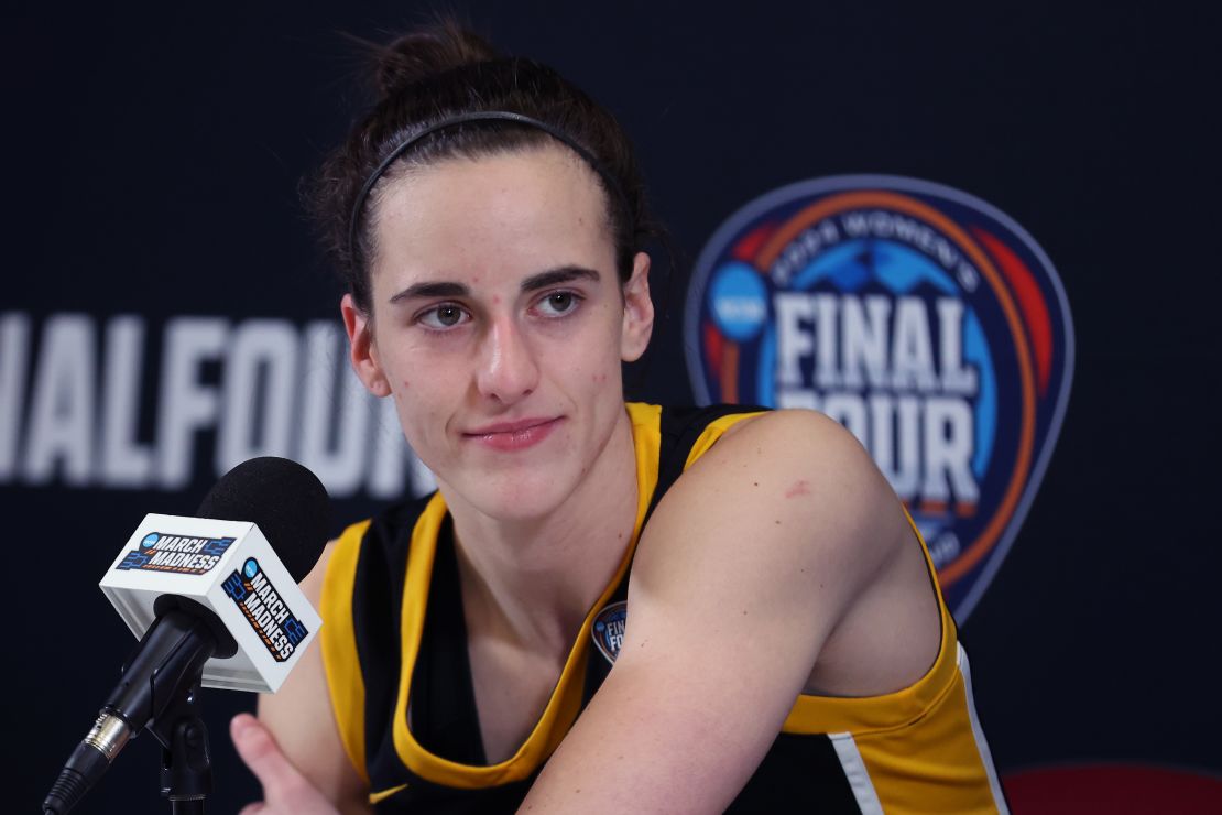 CLEVELAND, OHIO - APRIL 07: Caitlin Clark #22 of the Iowa Hawkeyes talks with the media after losing to the South Carolina Gamecocks in the 2024 NCAA Women's Basketball Tournament National Championship at Rocket Mortgage FieldHouse on April 07, 2024 in Cleveland, Ohio. South Carolina beat Iowa 87-75. (Photo by Steph Chambers/Getty Images)