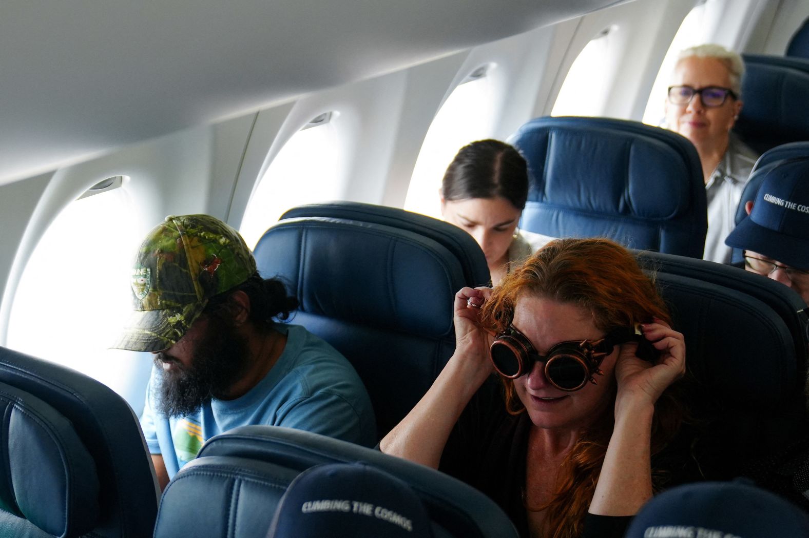Passengers sit on a special <a href="https://www.cnn.com/world/live-news/total-solar-eclipse-04-08-24-scn/h_0805aad2fa0453937598c63c98371f2f" target="_blank">path-of-totality flight</a> offered by Delta Air Lines on Monday.