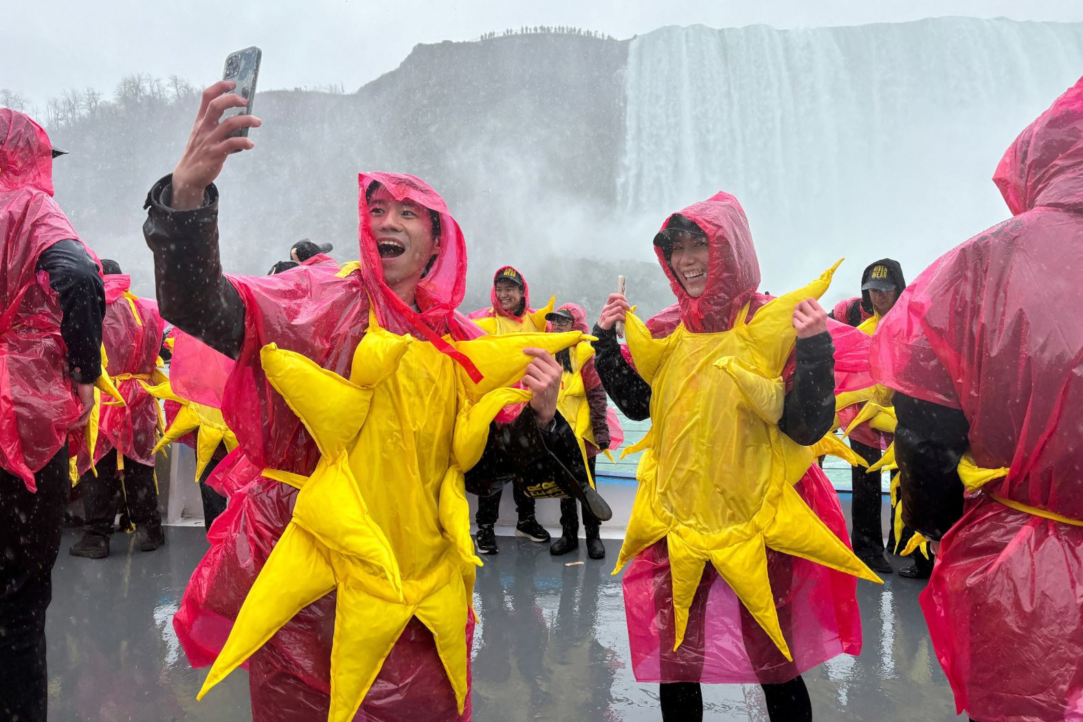 People in Niagara Falls gather on a sightseeing boat to break the Guinness World Record for the largest group of people dressed as the sun (309).