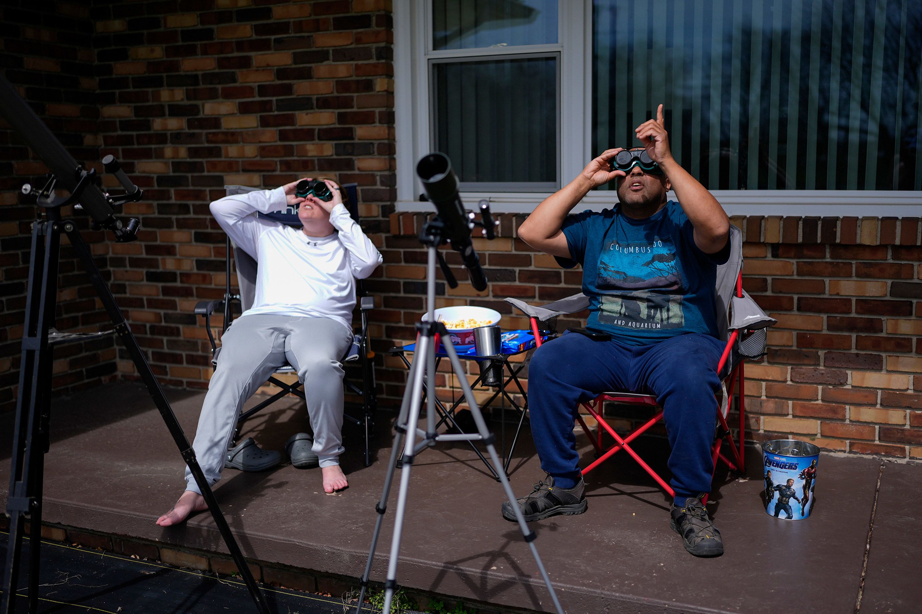 Melissa and Michael Richards use solar goggles to watch the eclipse in Wooster, Ohio.