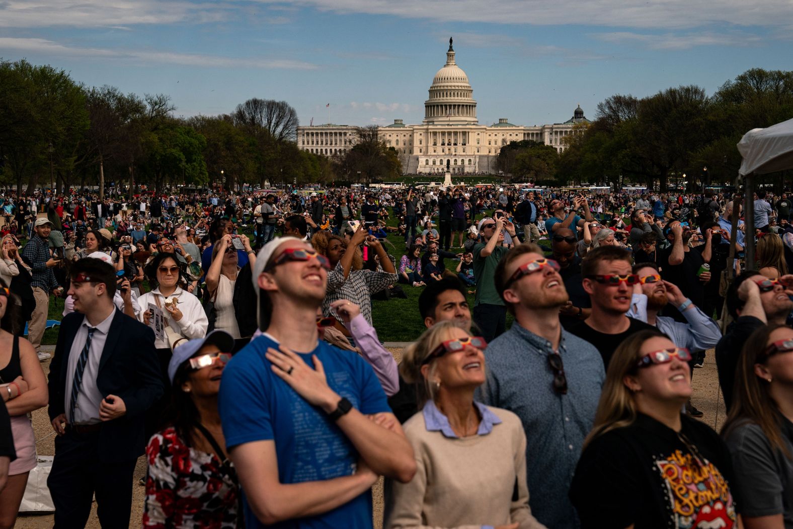 People gather on the National Mall in Washington, DC, to view the eclipse.