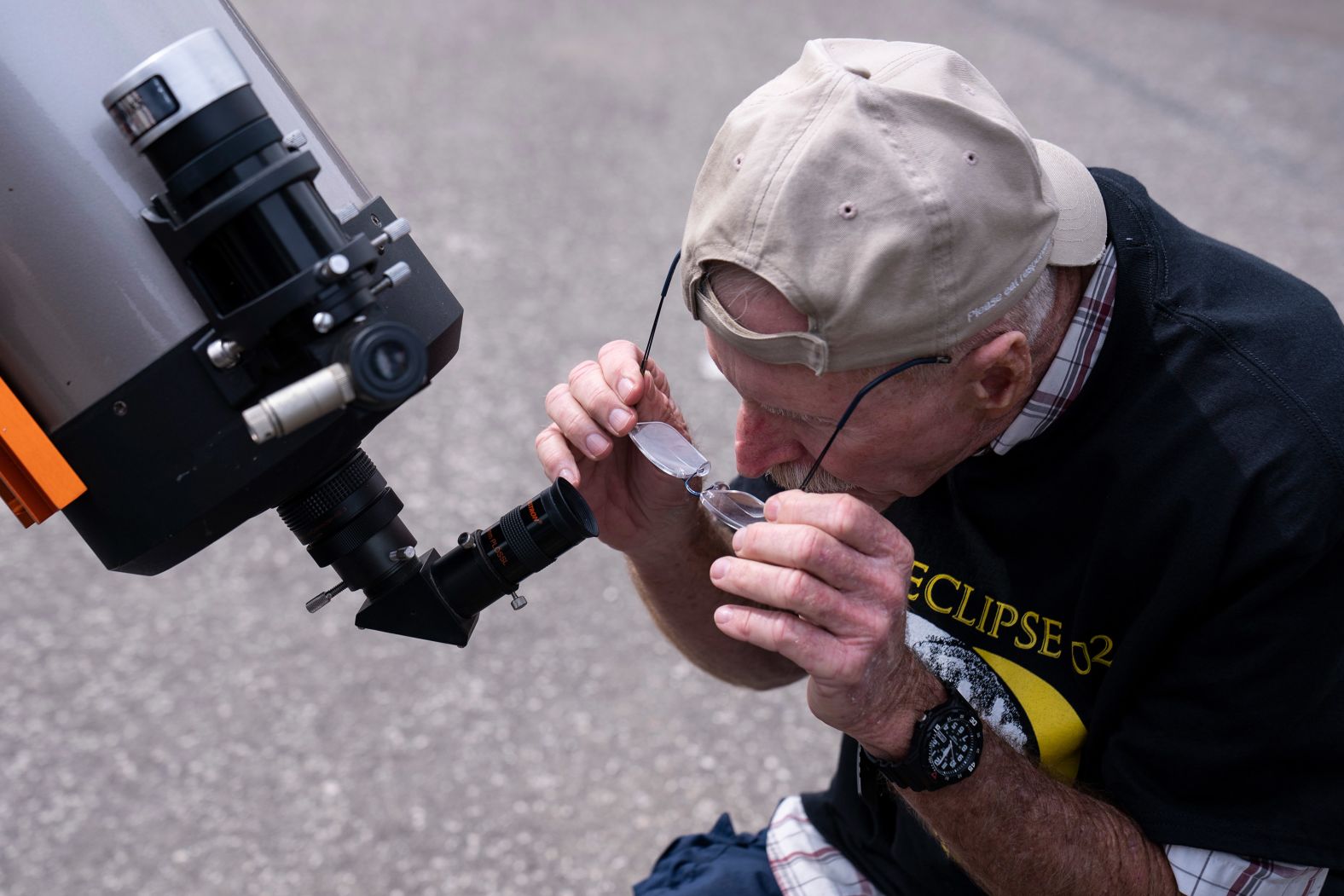 A National Park volunteer looks through a telescope at the eclipse watch party at the Amistad National Recreational Area in Del Rio.