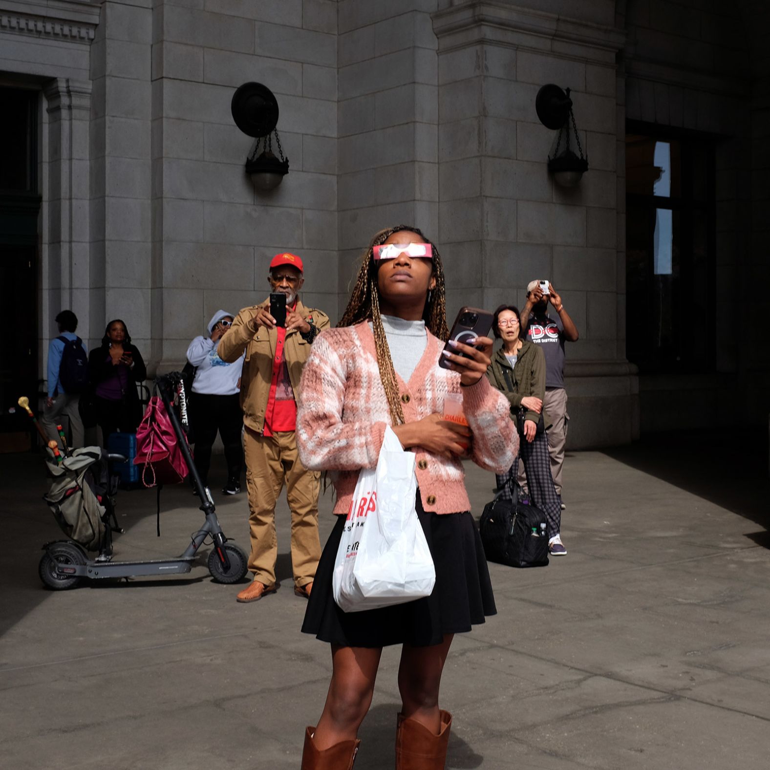 Nataya Tindle watches the eclipse outside of Union Station in Washington, DC.
