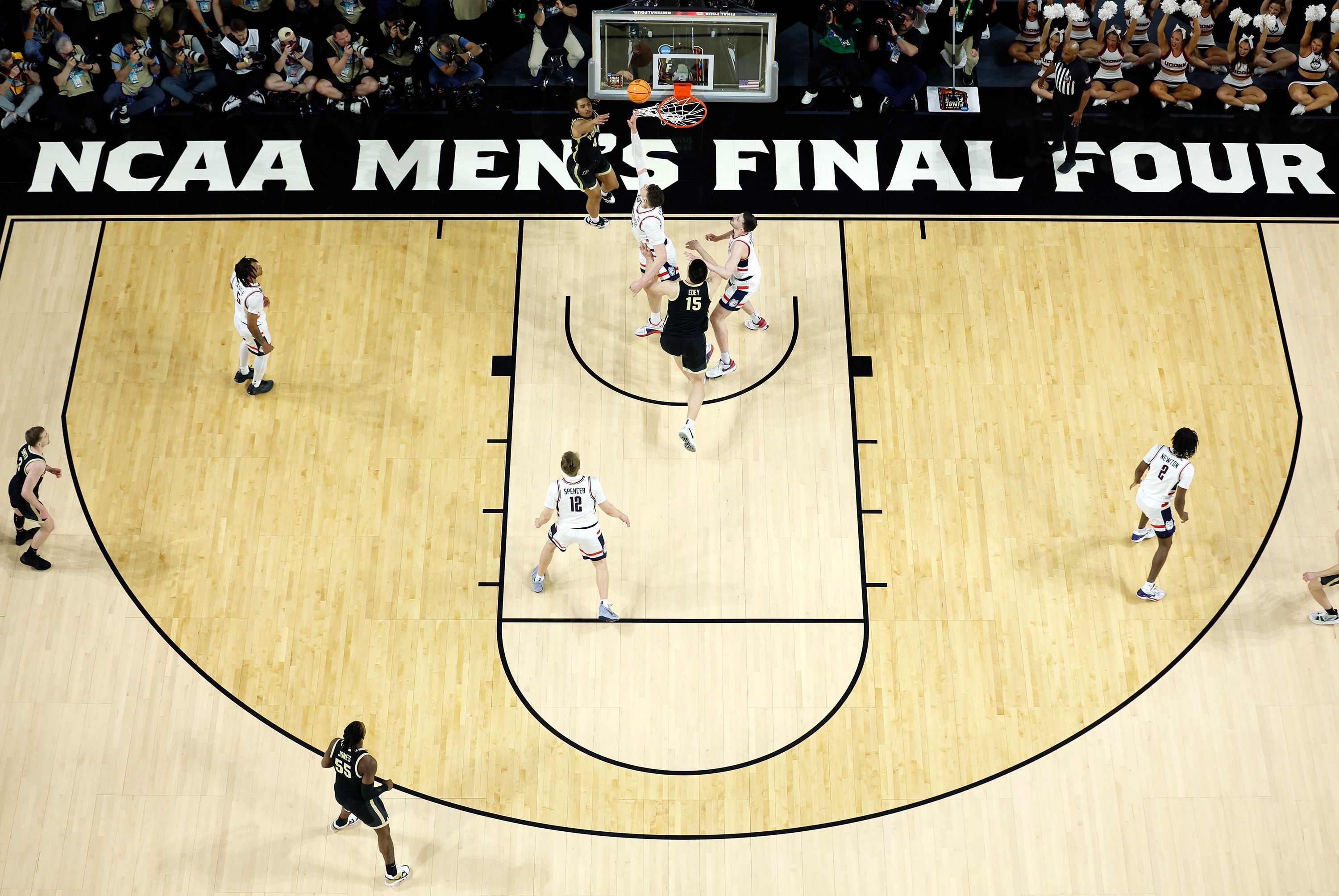 Trey Kaufman-Renn of the Purdue Boilermakers is guarded by UConn's Donovan Clingan.